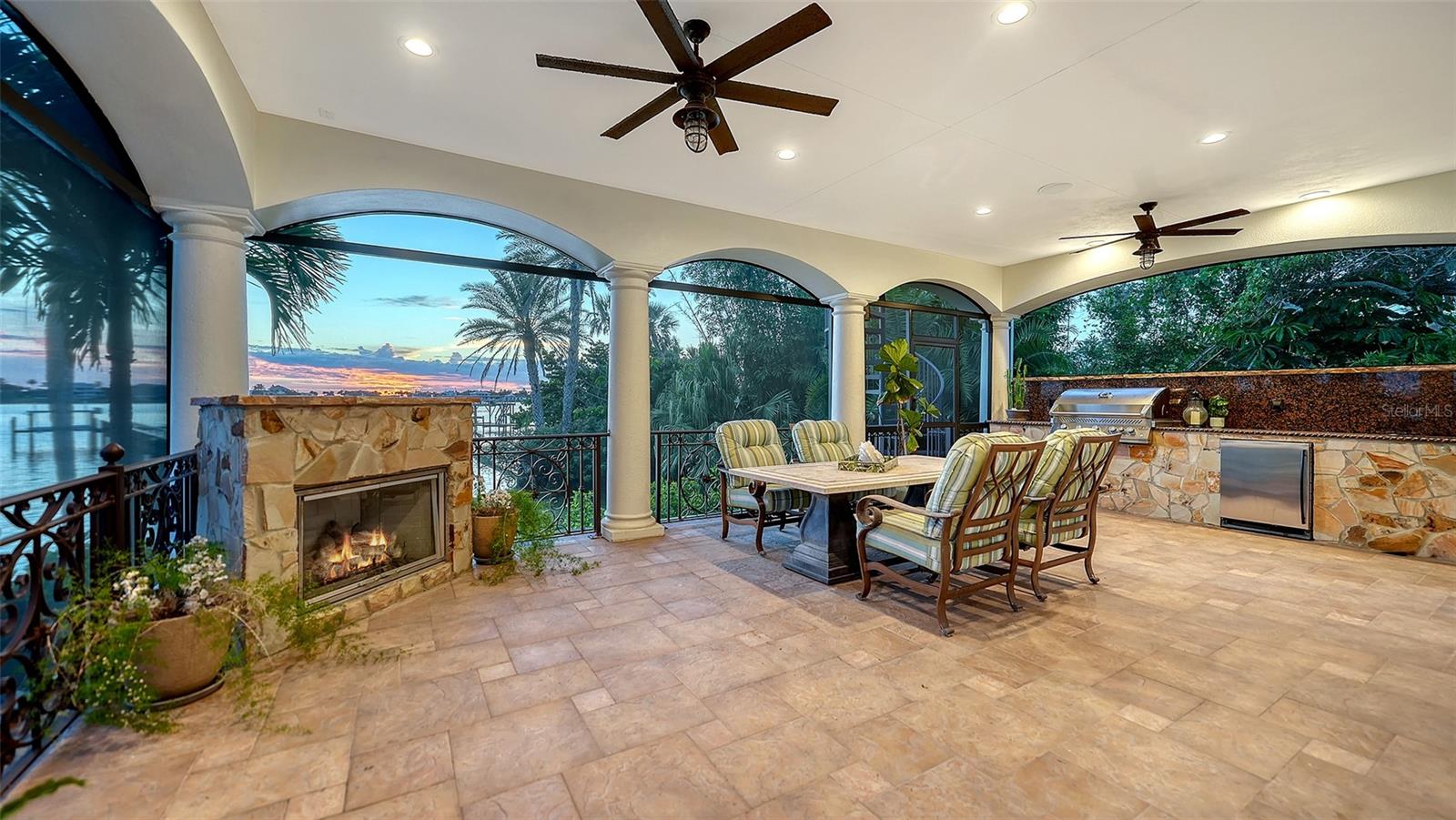 Outdoor living off the family room, with screening so no bugs allowed in while dining or relaxing by the gas fireplace - 2115 LYCHEE LN, NOKOMIS