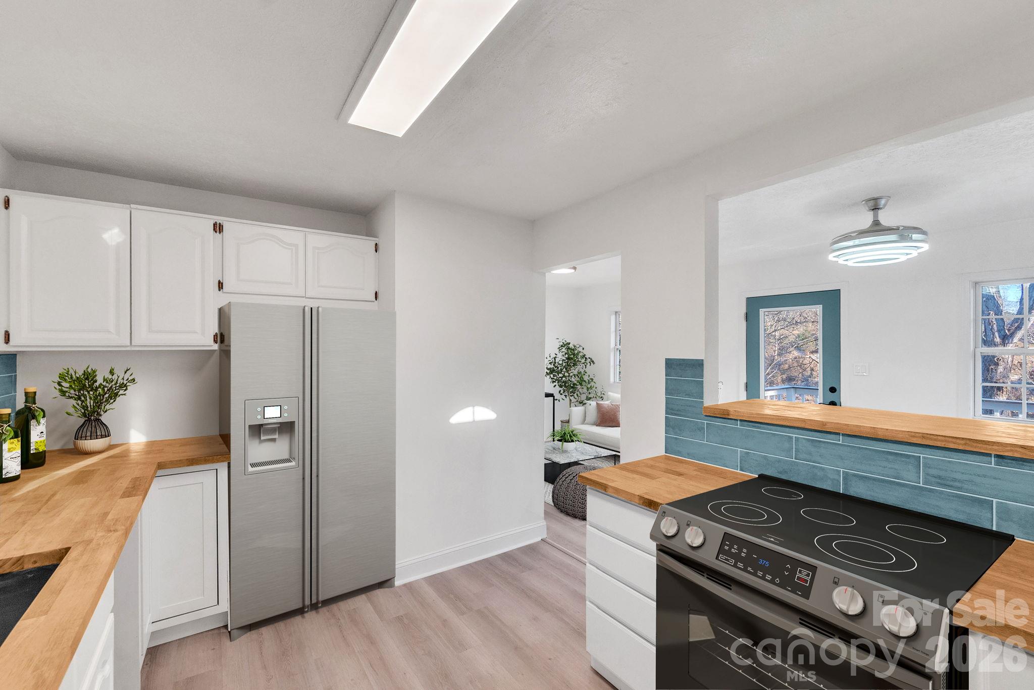 Open pass-through from kitchen into dining space. - 49 Livingston Street, Tryon