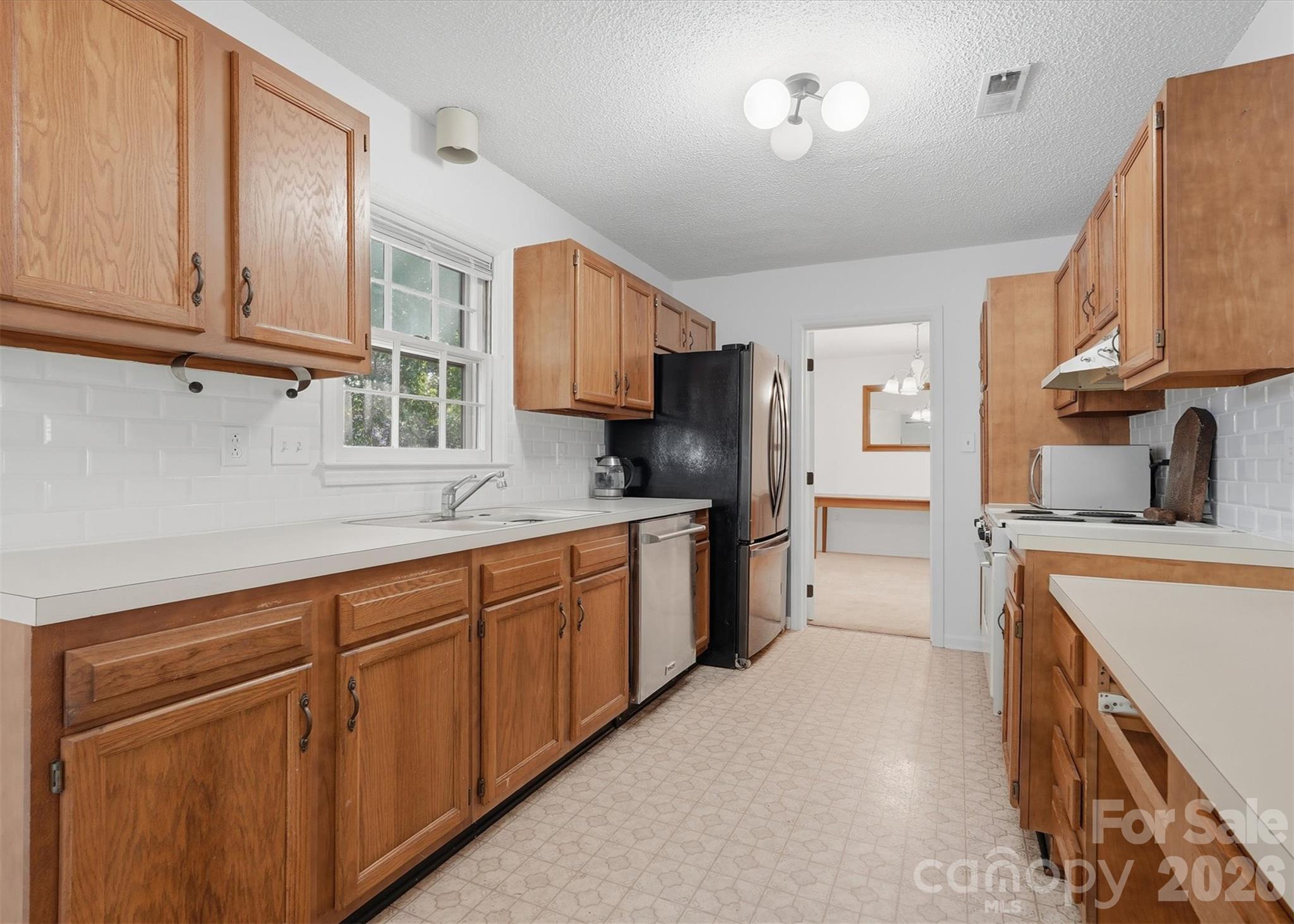 Kitchen leads to the Dining Room - 7214 Falconwood Court, Charlotte
