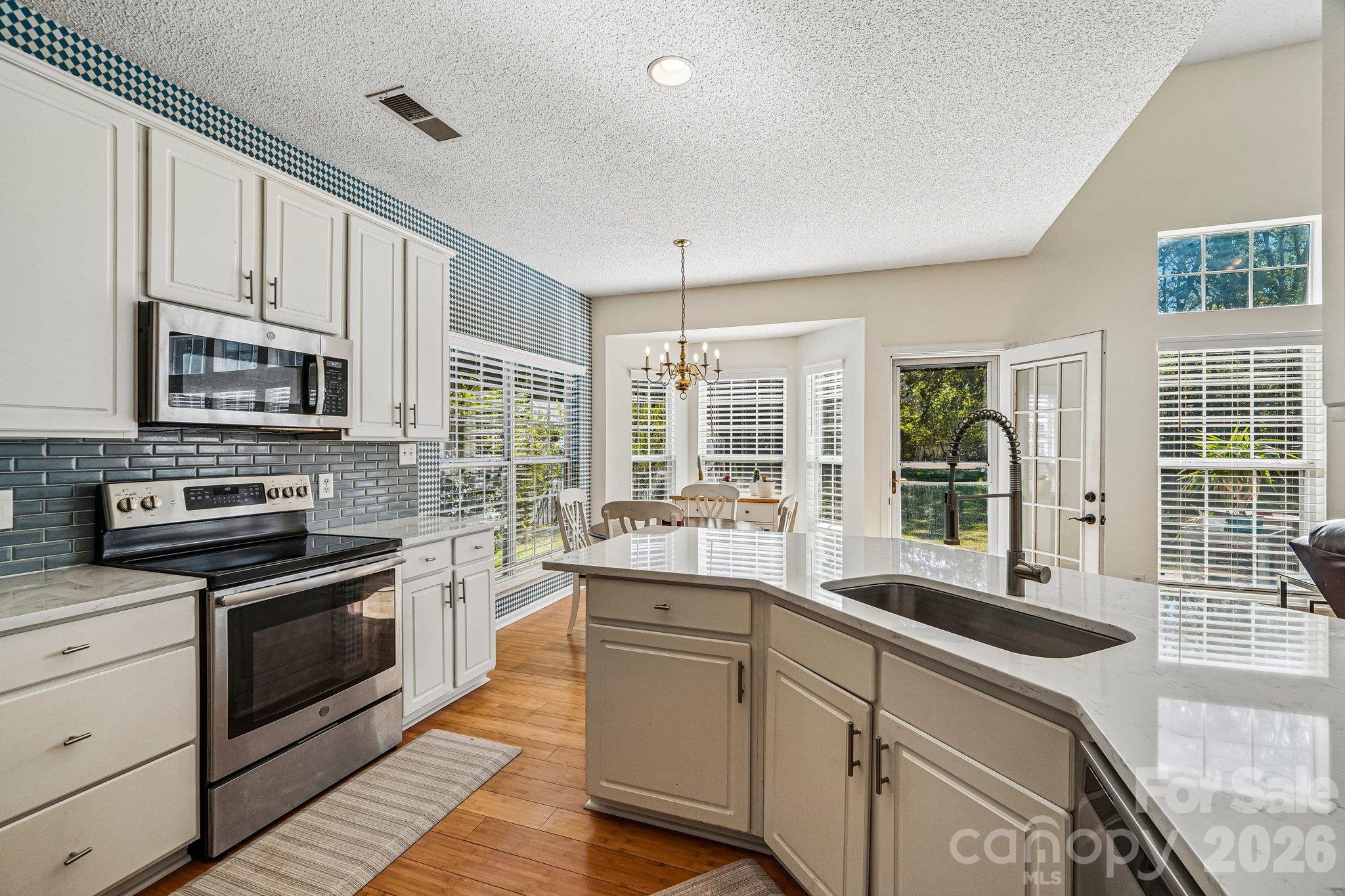 Kitchen opens to the breakfast nook and living room. - 11207 Livingston Mill Road, Charlotte