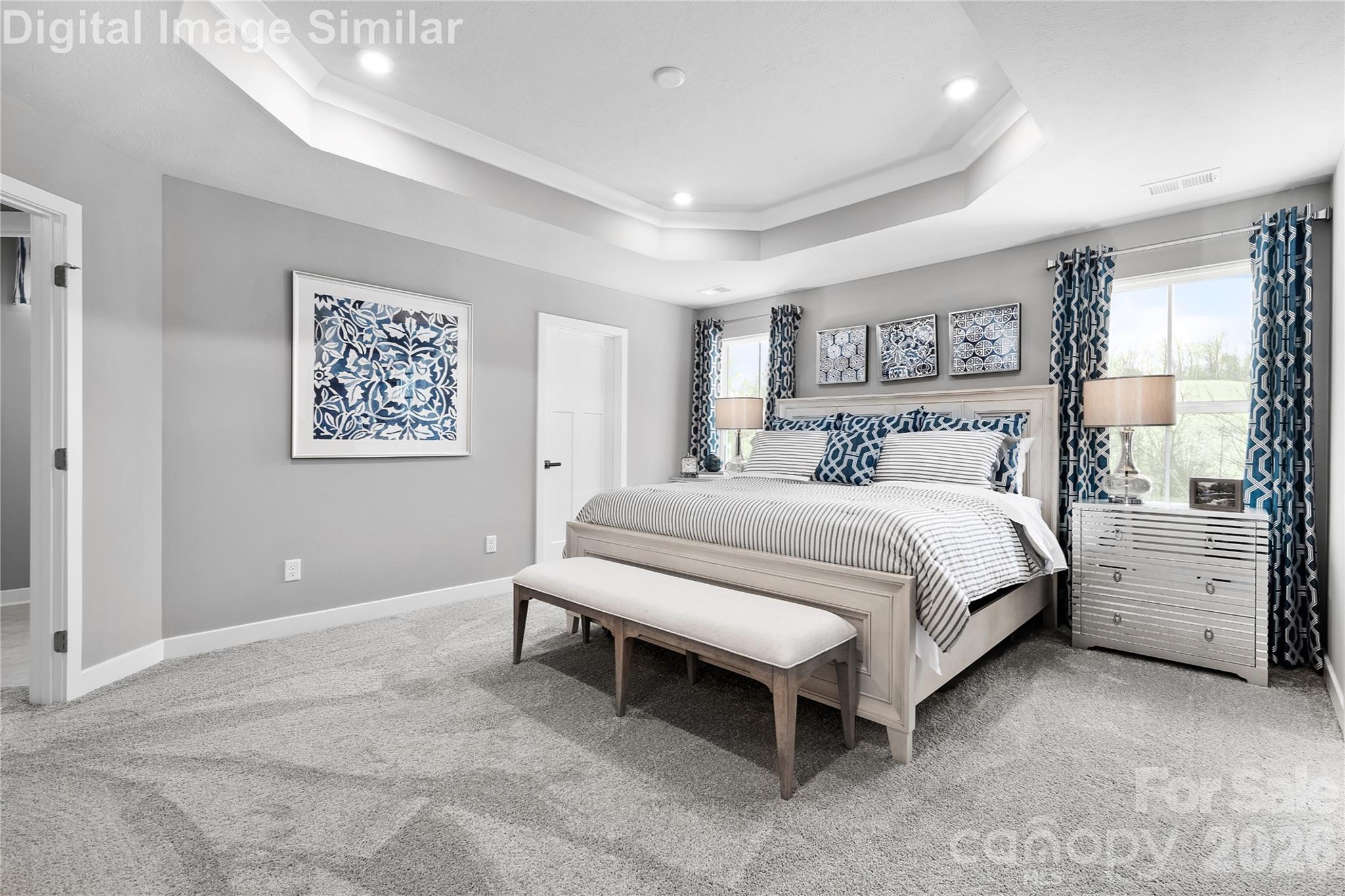 Dreamy owner’s suite with expansive windows that fill the space with natural light. Optional tray ceiling adds elegance. Easily fits a king-size bed with room to spare—ready to be styled your way. - 11204 Emerson Landing Drive, Charlotte