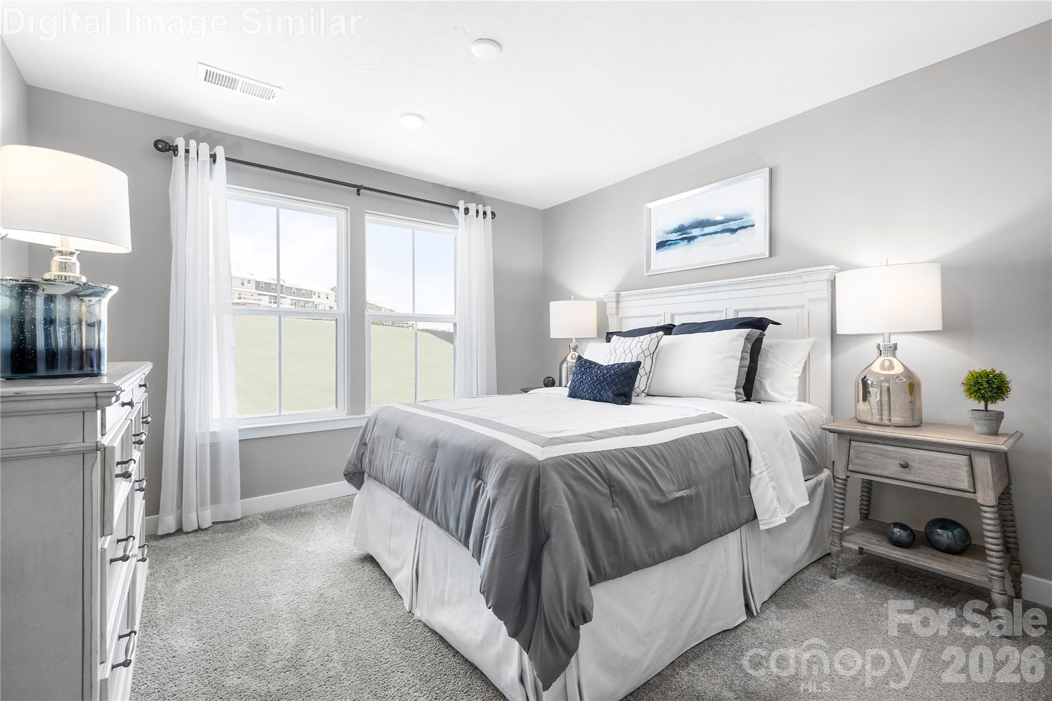 Comfortably sized guest bedroom with two large windows—bright, inviting, and ready to be styled to suit any taste. - 11204 Emerson Landing Drive, Charlotte