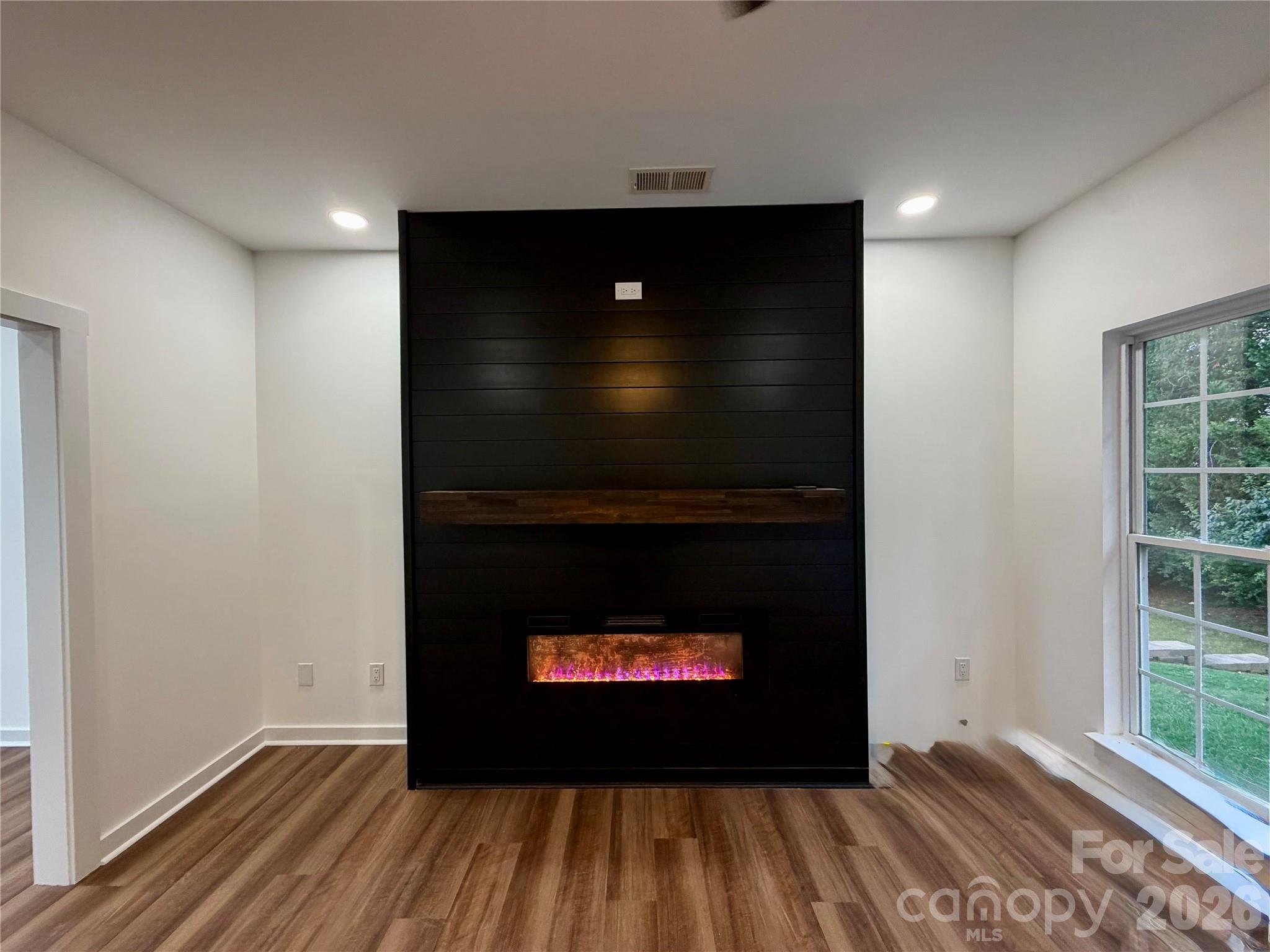 Den with Built in fireplace in Wall. It does have a blower. NEW LVP Flooring on main level. - 116 Huckleberry Lane, Mount Holly