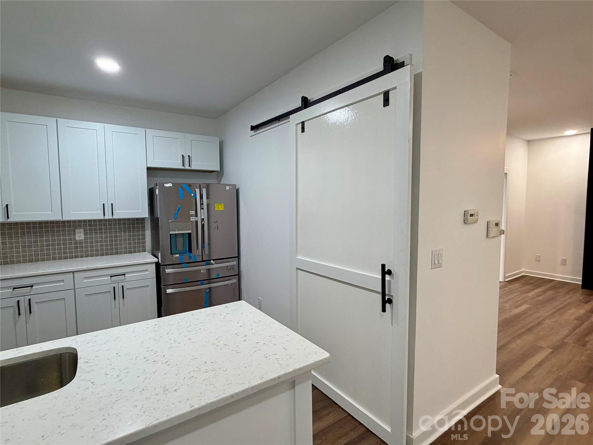 Pantry with a sliding barn door for privacy. NEW LVP Flooring on main level. - 116 Huckleberry Lane, Mount Holly