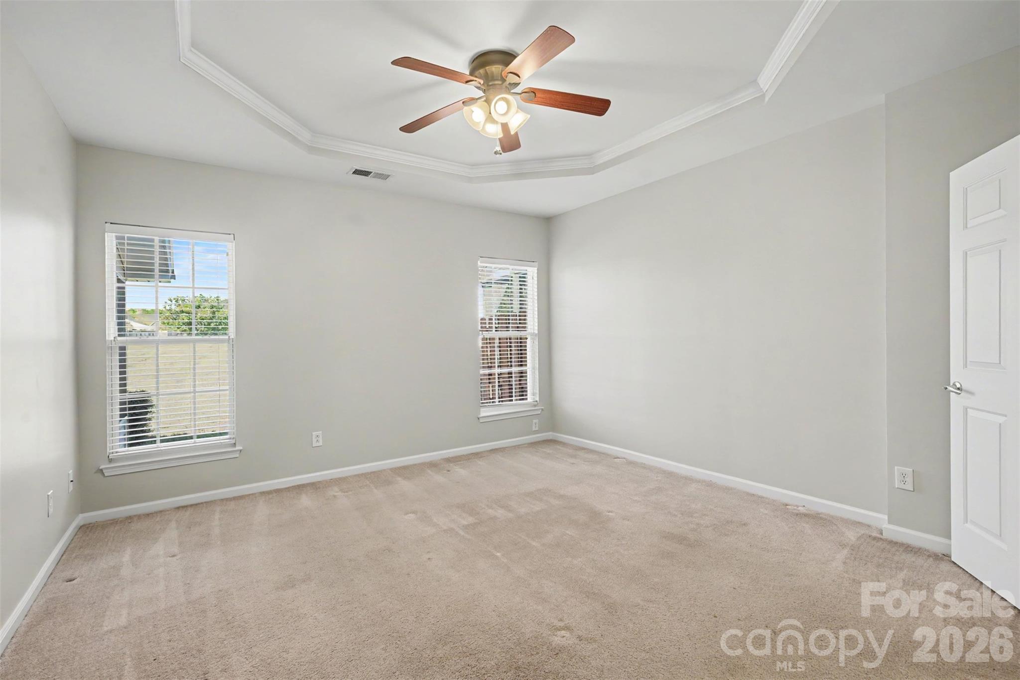 Main level primary bedroom with trey ceiling - 4083 Holly Villa Circle, Indian Trail