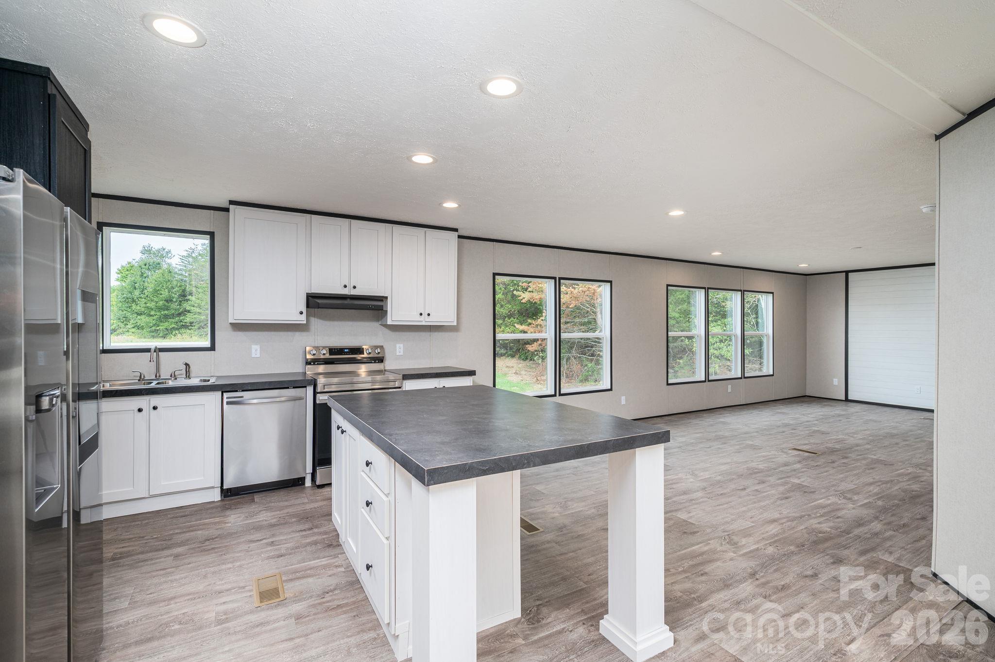 Kitchen with view into living/dining area - 207 Grassy Field Court, Lawndale