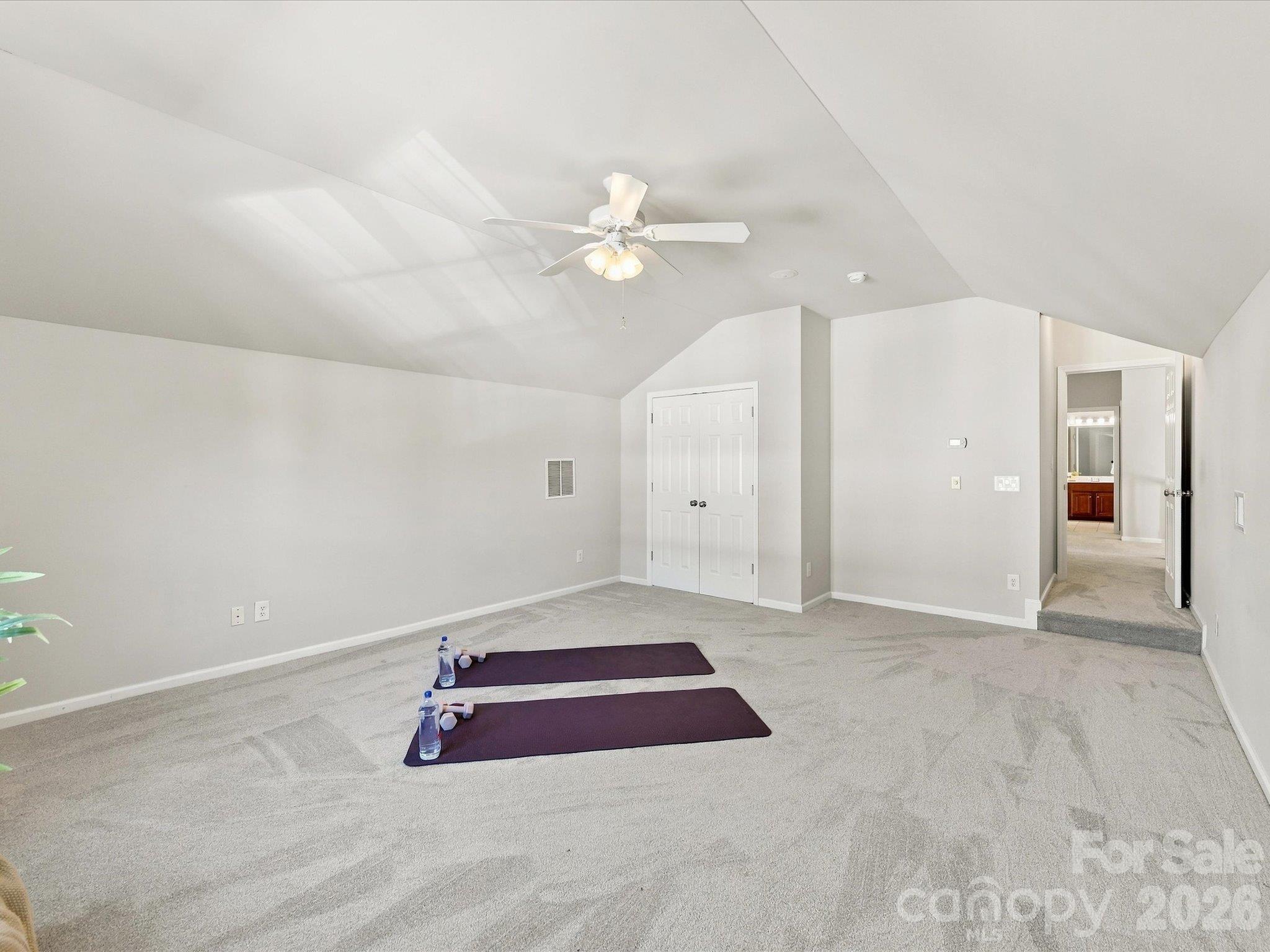 Expansive bonus room with vaulted ceilings and endless flexibility, offering the perfect space for a media room, playroom, home gym, or additional living area. - 1788 Oakmont Drive, Denver