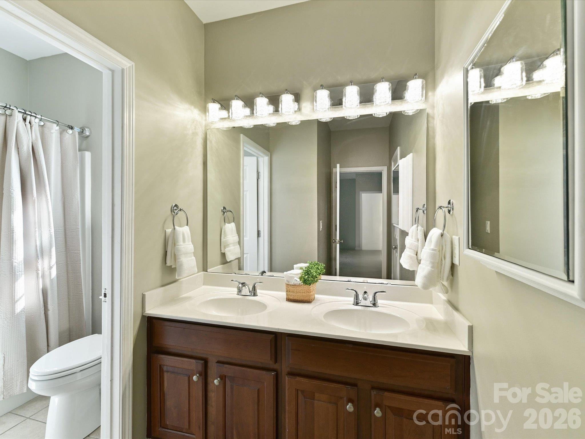 Spacious full bath featuring a dual-sink vanity and a private tub/shower area, providing comfort and convenience for family and guests alike. - 1788 Oakmont Drive, Denver
