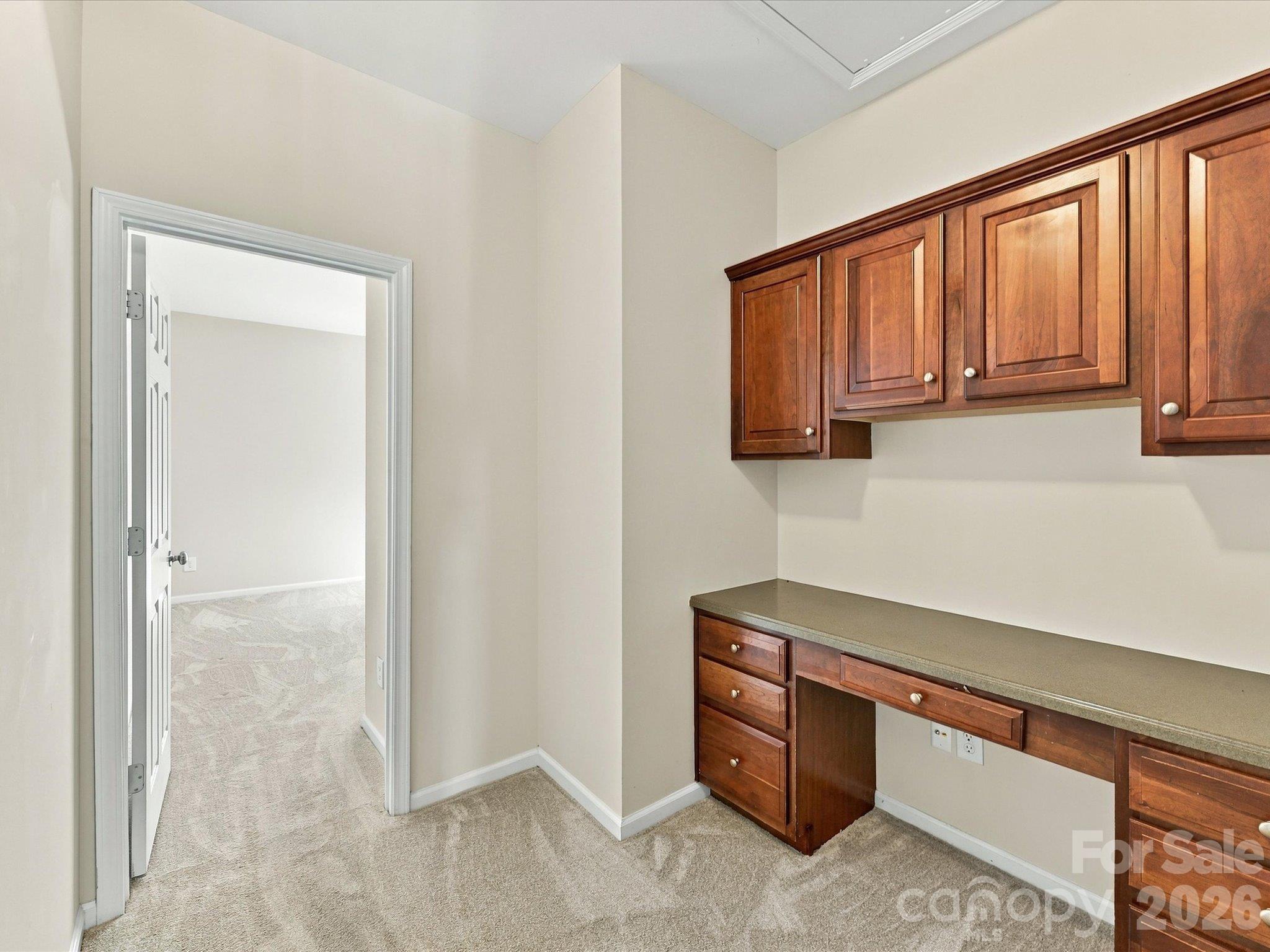 Dedicated built-in workspace with custom cabinetry, generous storage, and a functional desk area—perfect for working from home, studying, or managing daily tasks. - 1788 Oakmont Drive, Denver