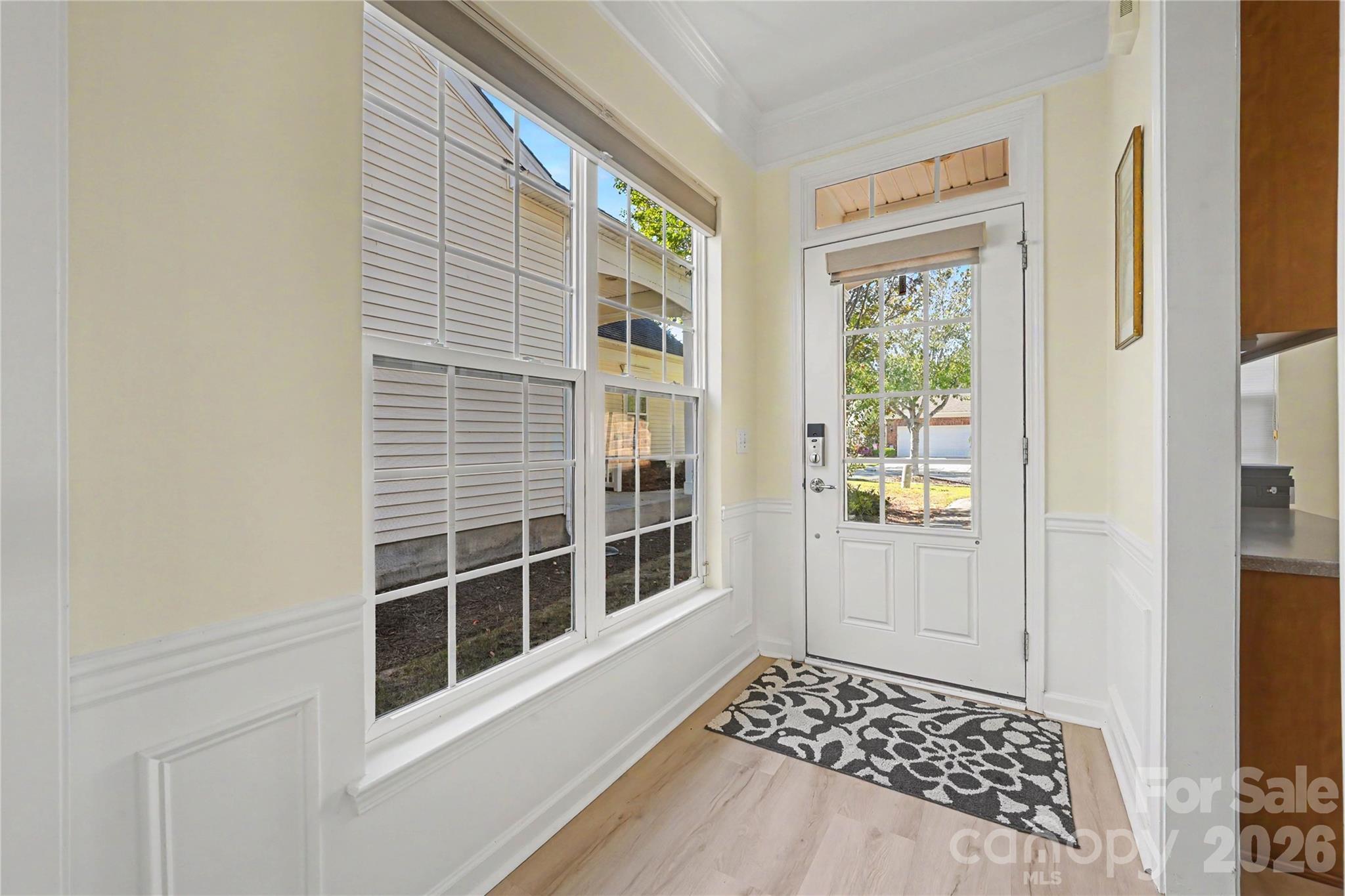 Hallway Entrance featuring LVP flooring, glass insert door and glass storm door. - 3054 Azalea Drive, Indian Land