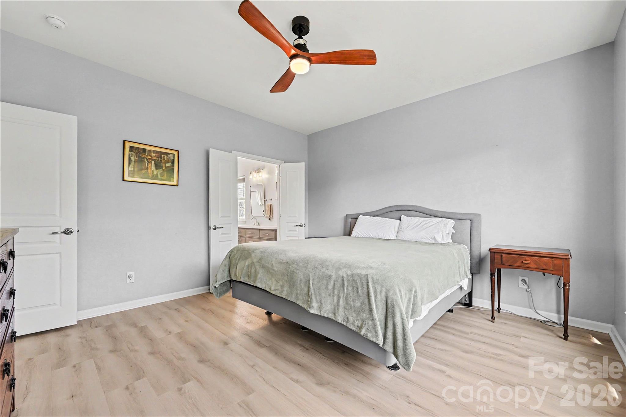 Primary Bedroom featuring NEW LVP flooring, neutral paint, ceiling fan, and plenty of room for a King Bed and furniture. - 3054 Azalea Drive, Indian Land