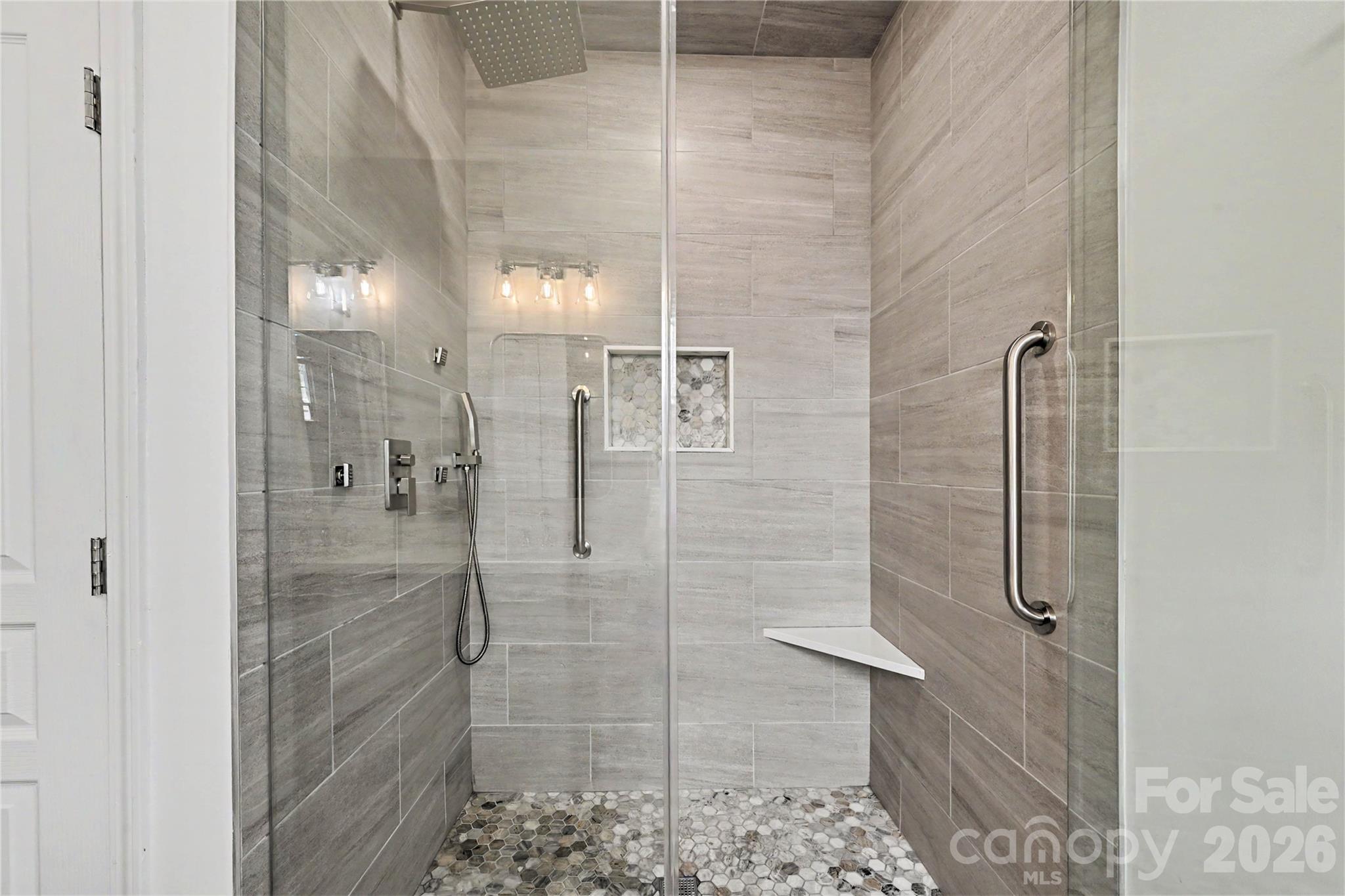 FABULOUS LUXURIOUS SHOWER featuring Body Jets, Rainshower head, handheld shower, FULL Ceiling to Floor tile with Tile Pan flooring, and Frameless Glass Door and Surround. - 3054 Azalea Drive, Indian Land