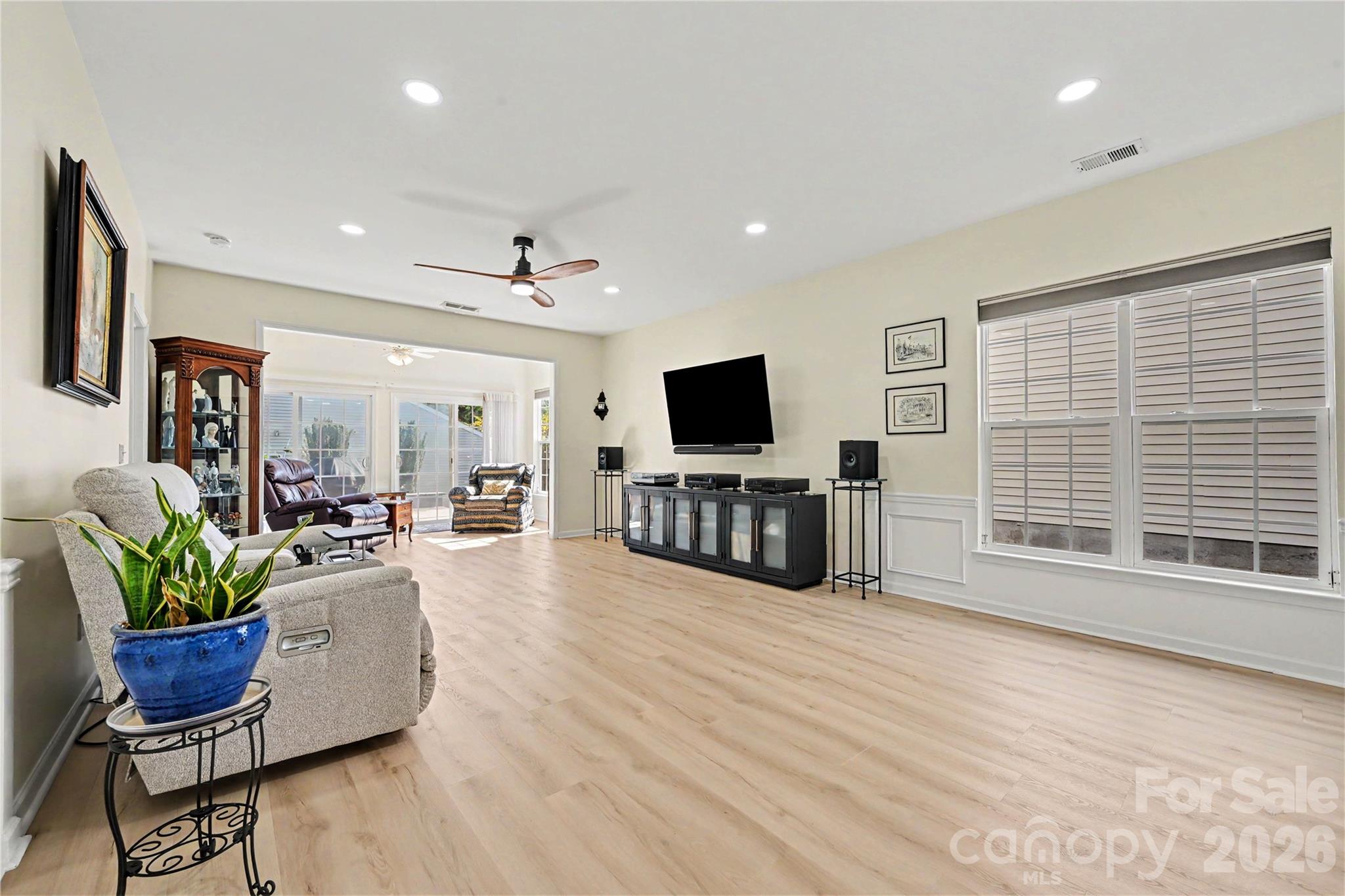 Another view of the Great Room showing NEW LVP flooring, neutral paint, LED flush ceiling lights, and bright views. - 3054 Azalea Drive, Indian Land