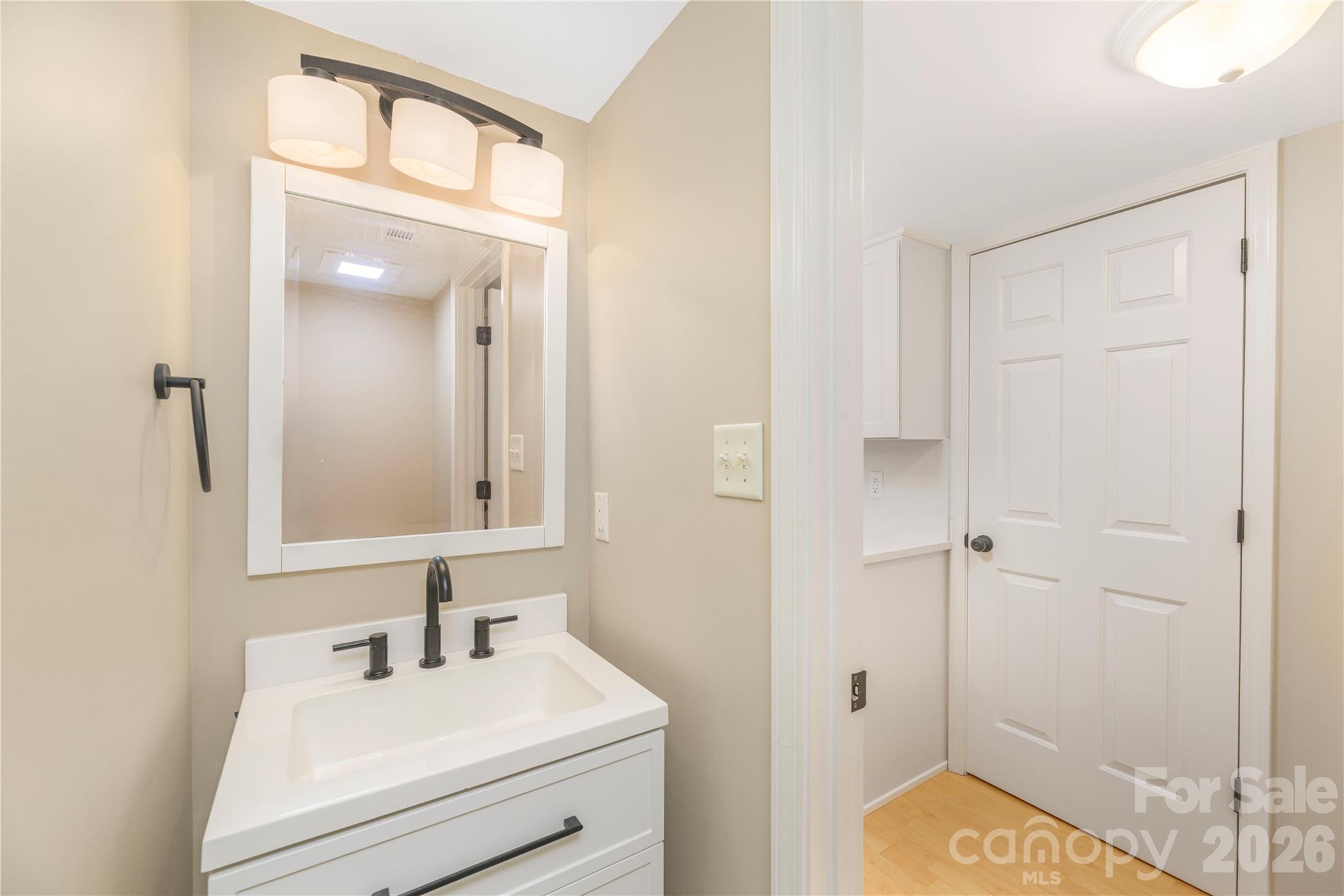 Updated half bathroom off of the kitchen. - 17 Sheridan Road, Asheville