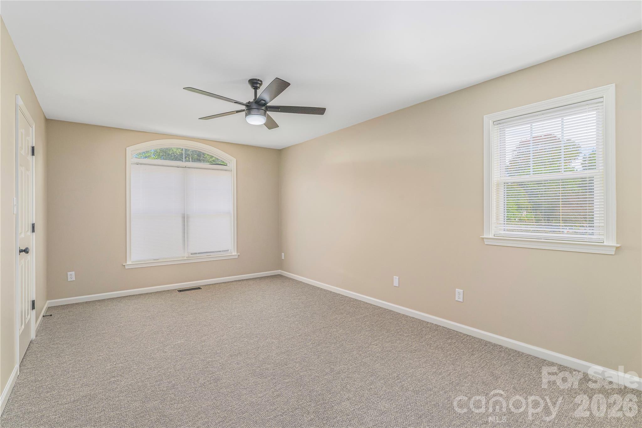 Spacious and light-filled primary bedroom on the upper level. - 17 Sheridan Road, Asheville