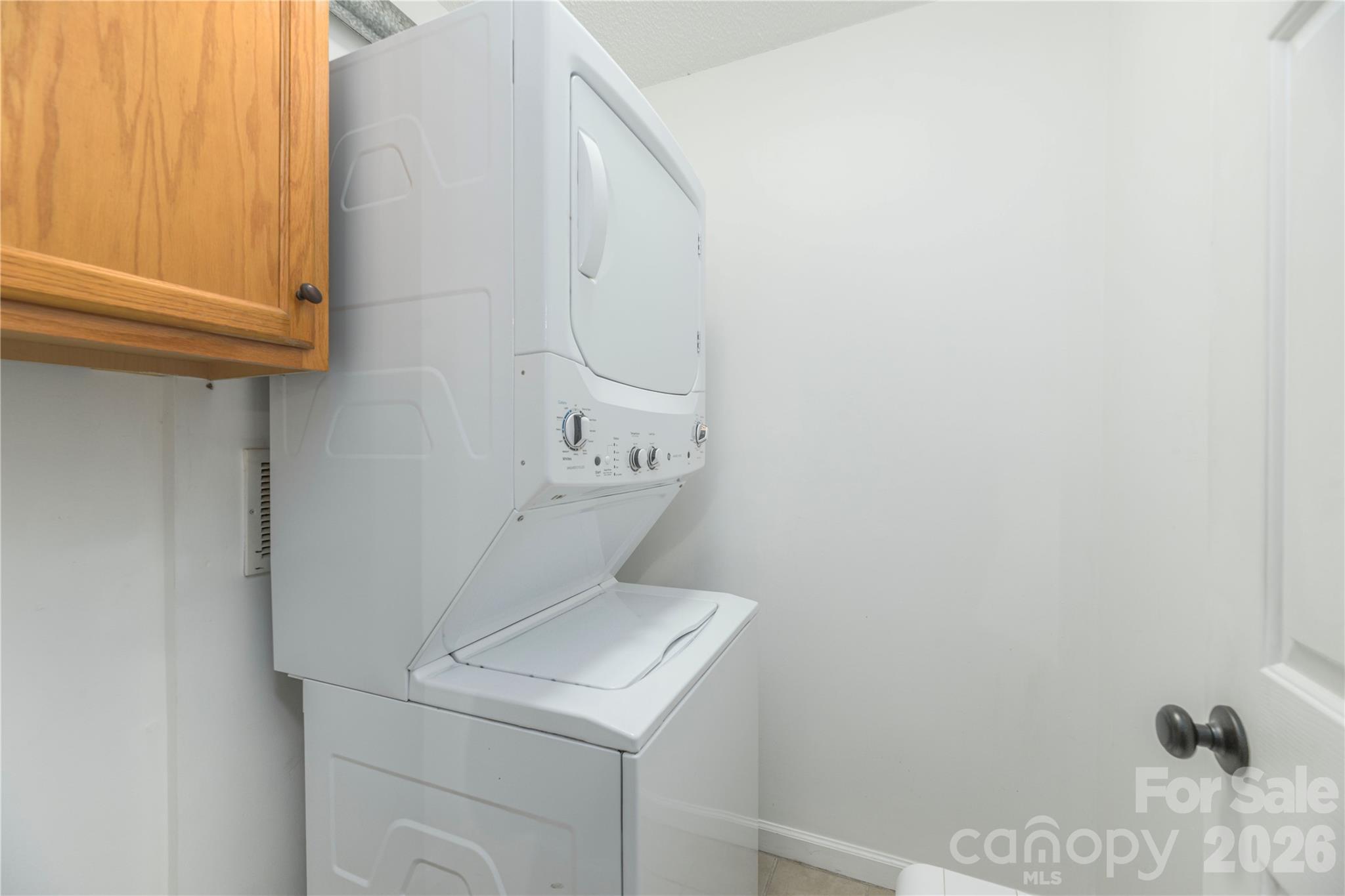 Separate stackable laundry in closet off of kitchen in the basement apartment. - 17 Sheridan Road, Asheville
