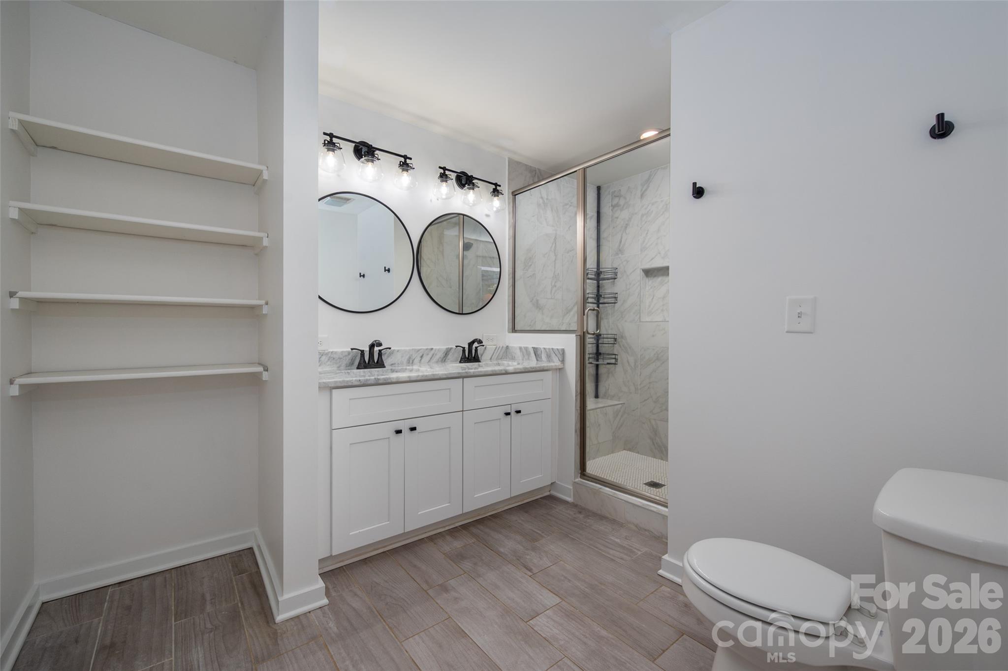 Lots of storage, large glass shower and double sinks in Primary Bath - 4238 Dowling Drive, Charlotte