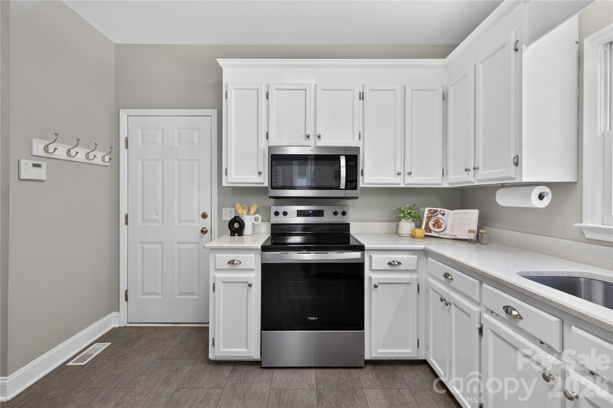 Kitchen with stainless steel appliances and quartz countertops. - 4711 Beech Crest Place, Charlotte