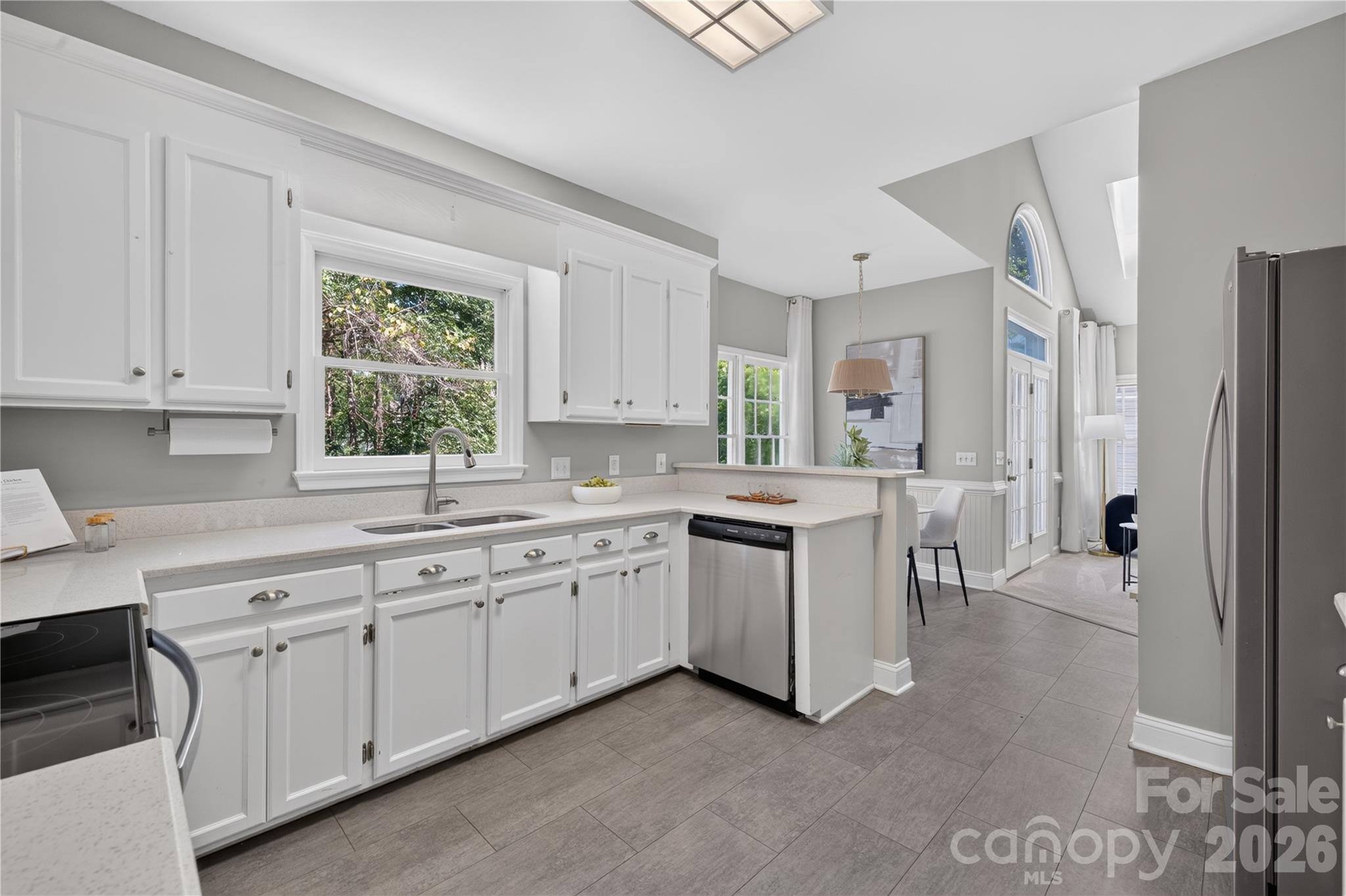 Kitchen with stainless steel appliances and quartz countertops. - 4711 Beech Crest Place, Charlotte