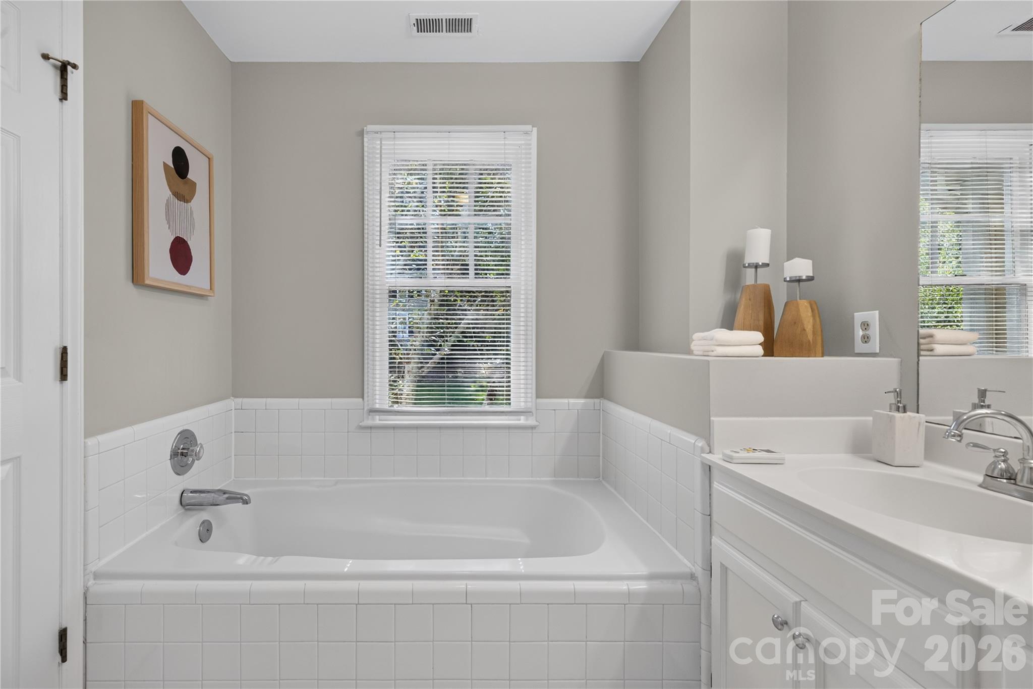 Spacious en suite bath with garden tub, dual vanity, new flooring and separate shower. - 4711 Beech Crest Place, Charlotte