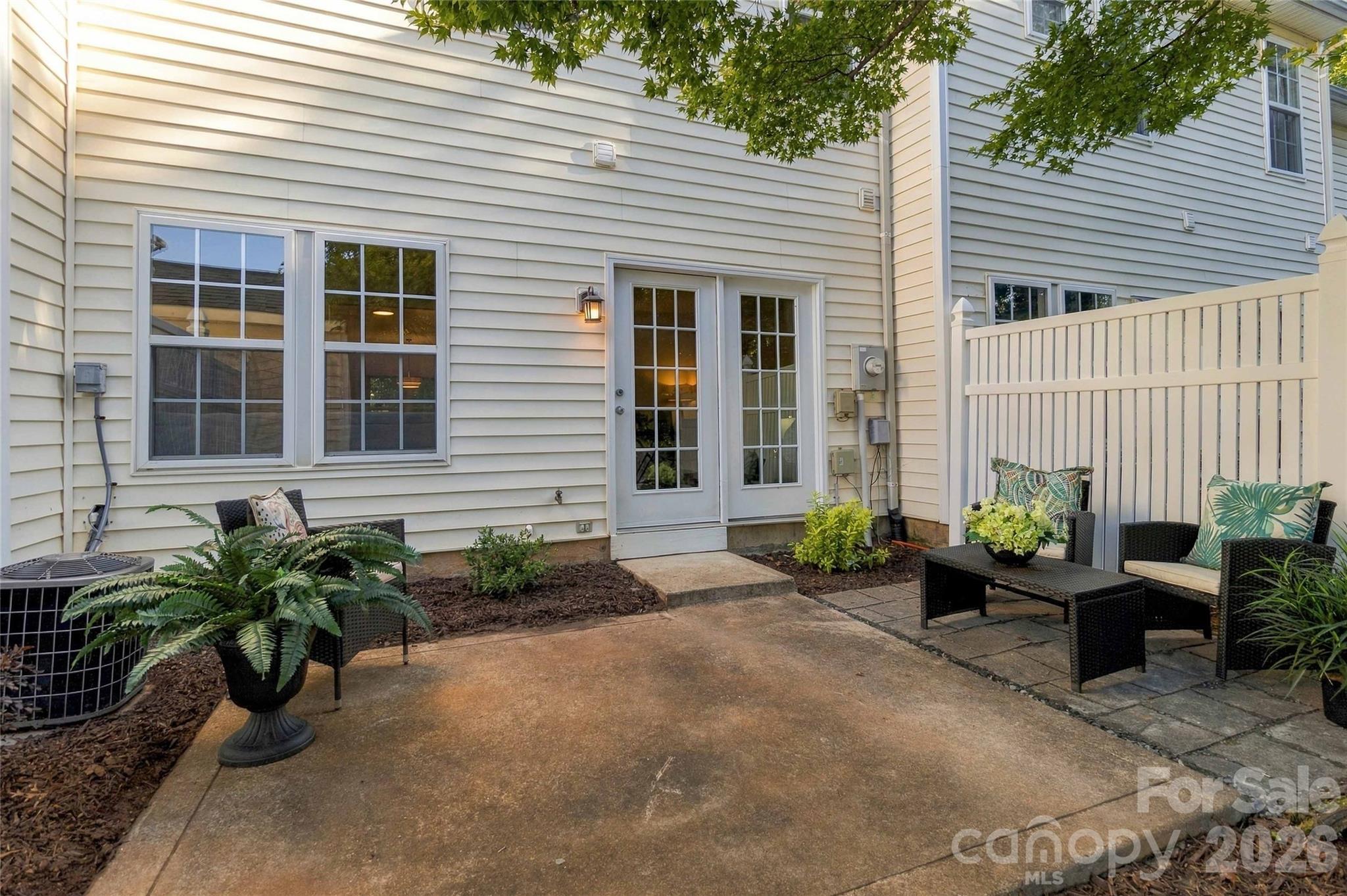 Fresh mulch and shrubs surround patio - 18631 Oakhurst Boulevard, Cornelius