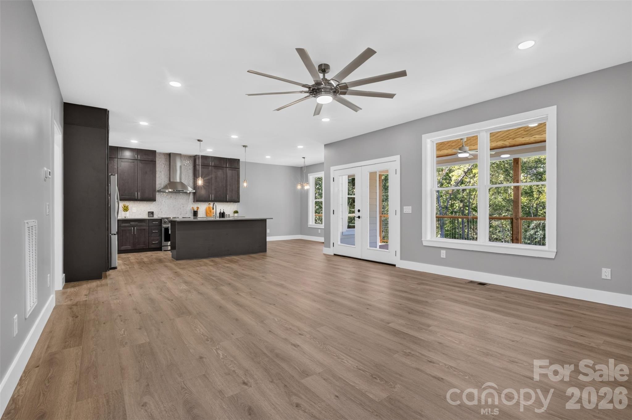 The French doors off the living room lead to the covered back deck. - 160 Pumice Drive, Statesville