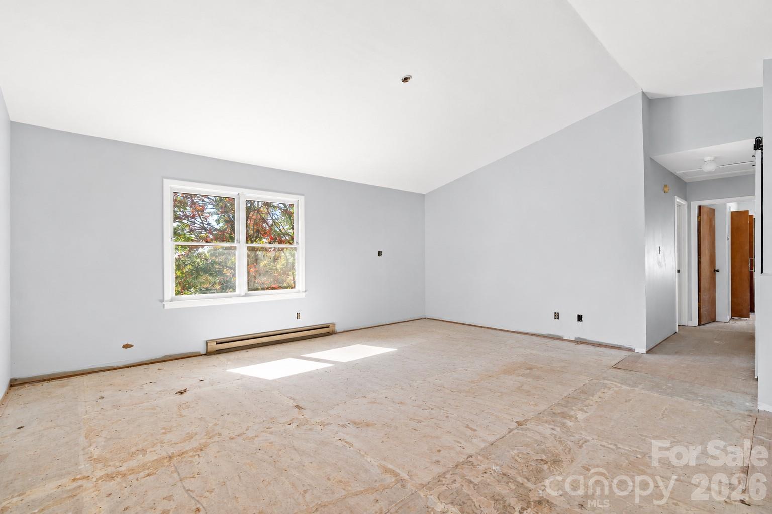 Light-filled living space with vaulted ceilings and plenty of room to make it your own. - 117 & 99999 Spivey Mountain Road, Asheville