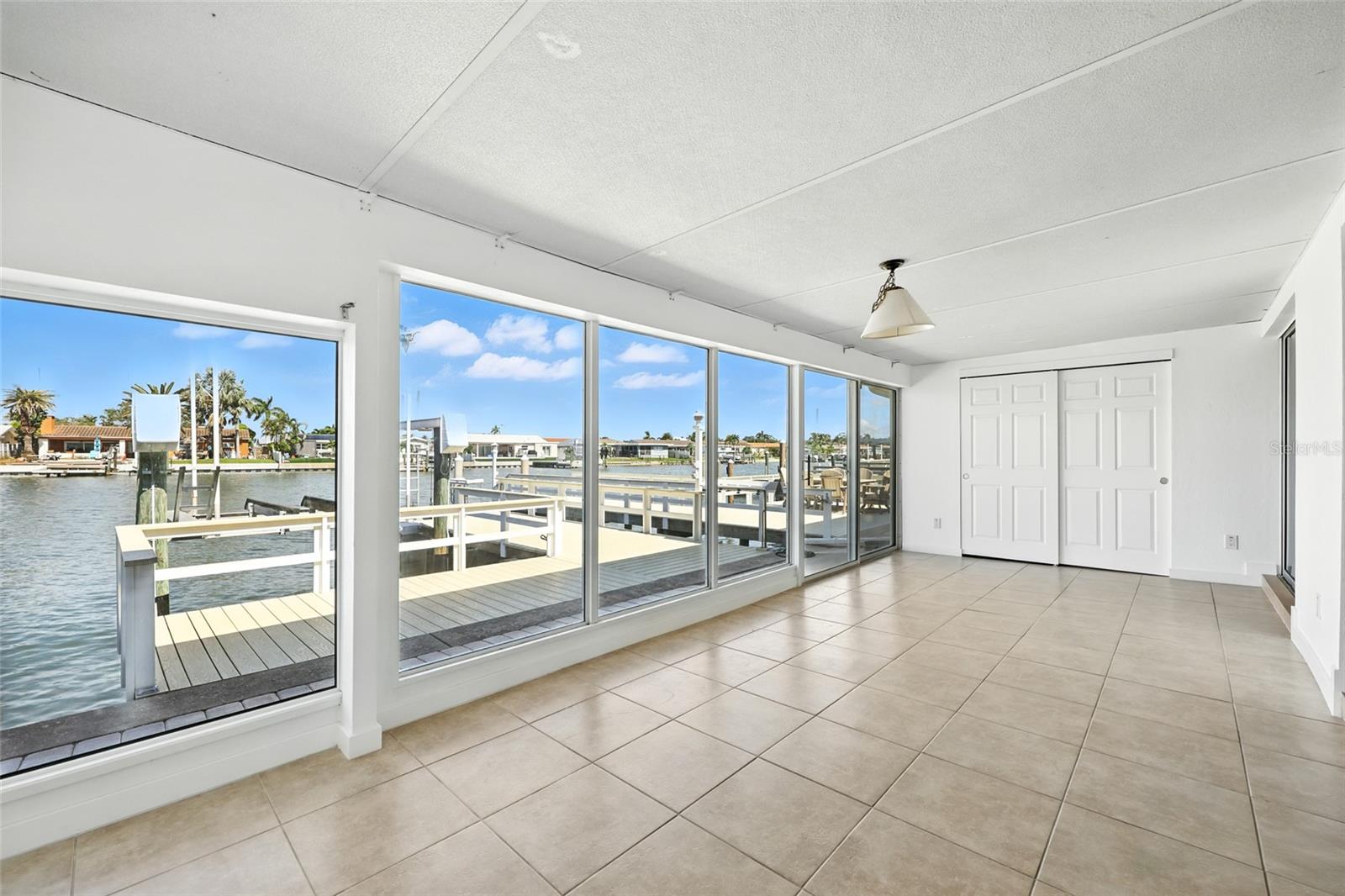The enclosed Florida room has a double polyurethane and aluminum roof which provides extra strength and sound protection.  The large closet in this room provides storage for your fishing and water sports equipment. - 545 BOCA CIEGA POINT BLVD N, ST PETERSBURG