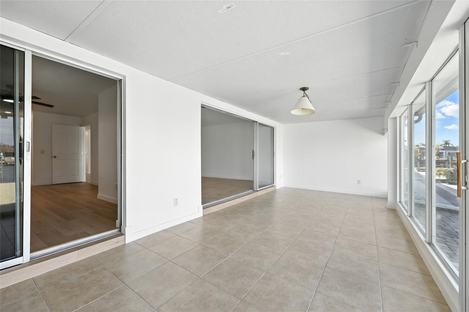 The enclosed Florida room has a double polyurethane and aluminum roof which provides extra strength and sound protection. - 545 BOCA CIEGA POINT BLVD N, ST PETERSBURG