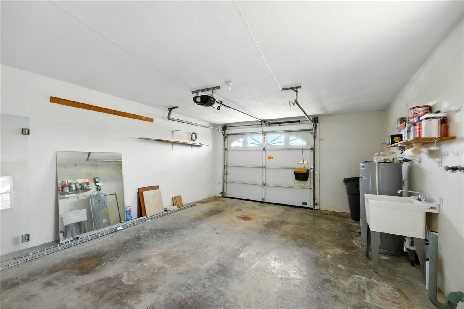 The oversized garage includes a remote garage door opener with all new sensors, hinges and cables, new sink, new water heater, laundry hookups, and plenty of room for additional storage. - 545 BOCA CIEGA POINT BLVD N, ST PETERSBURG