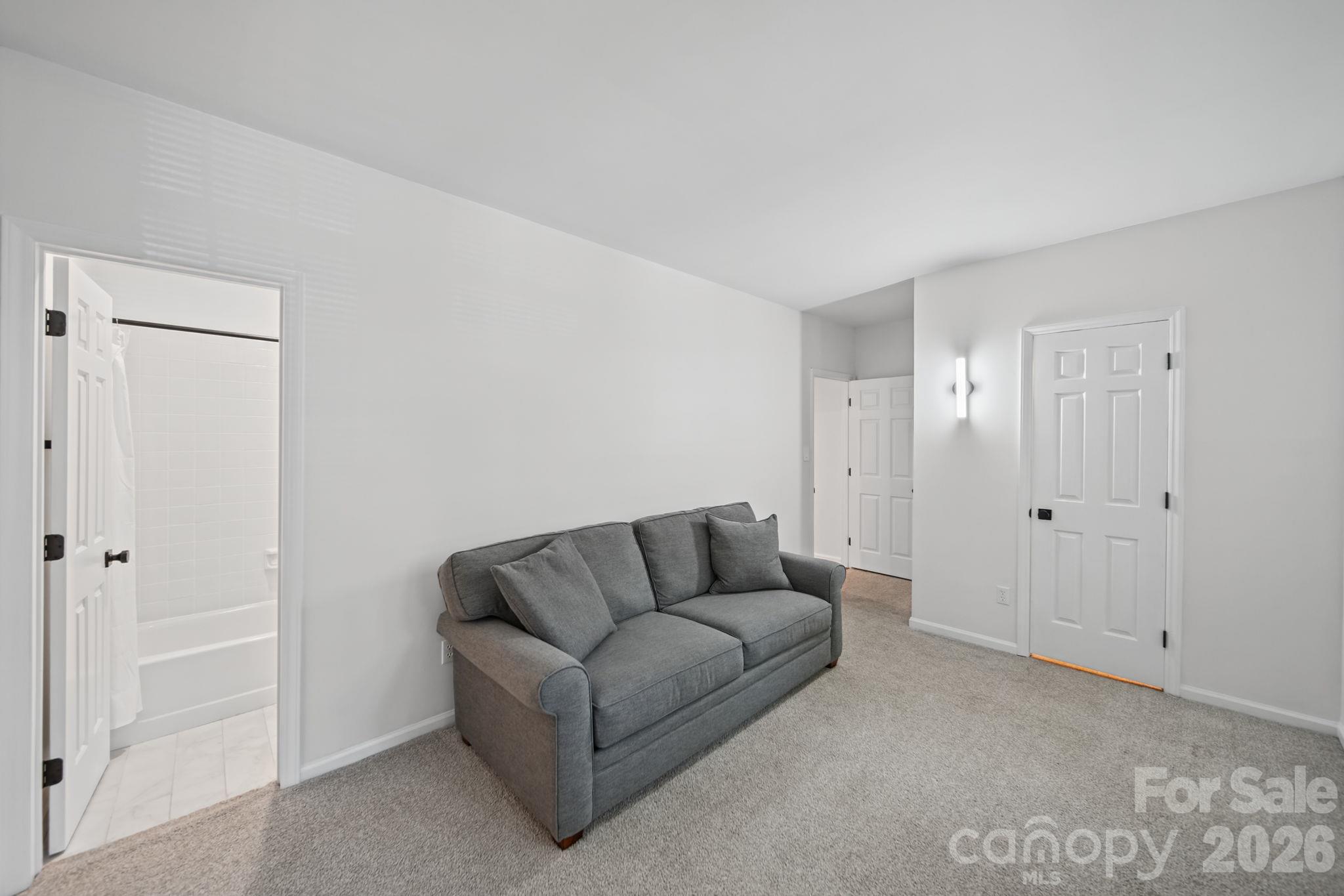 Large Secondary Bedroom displaying private bathroom entrance and walk in closet - 3302 Selwyn Farms Lane, Charlotte