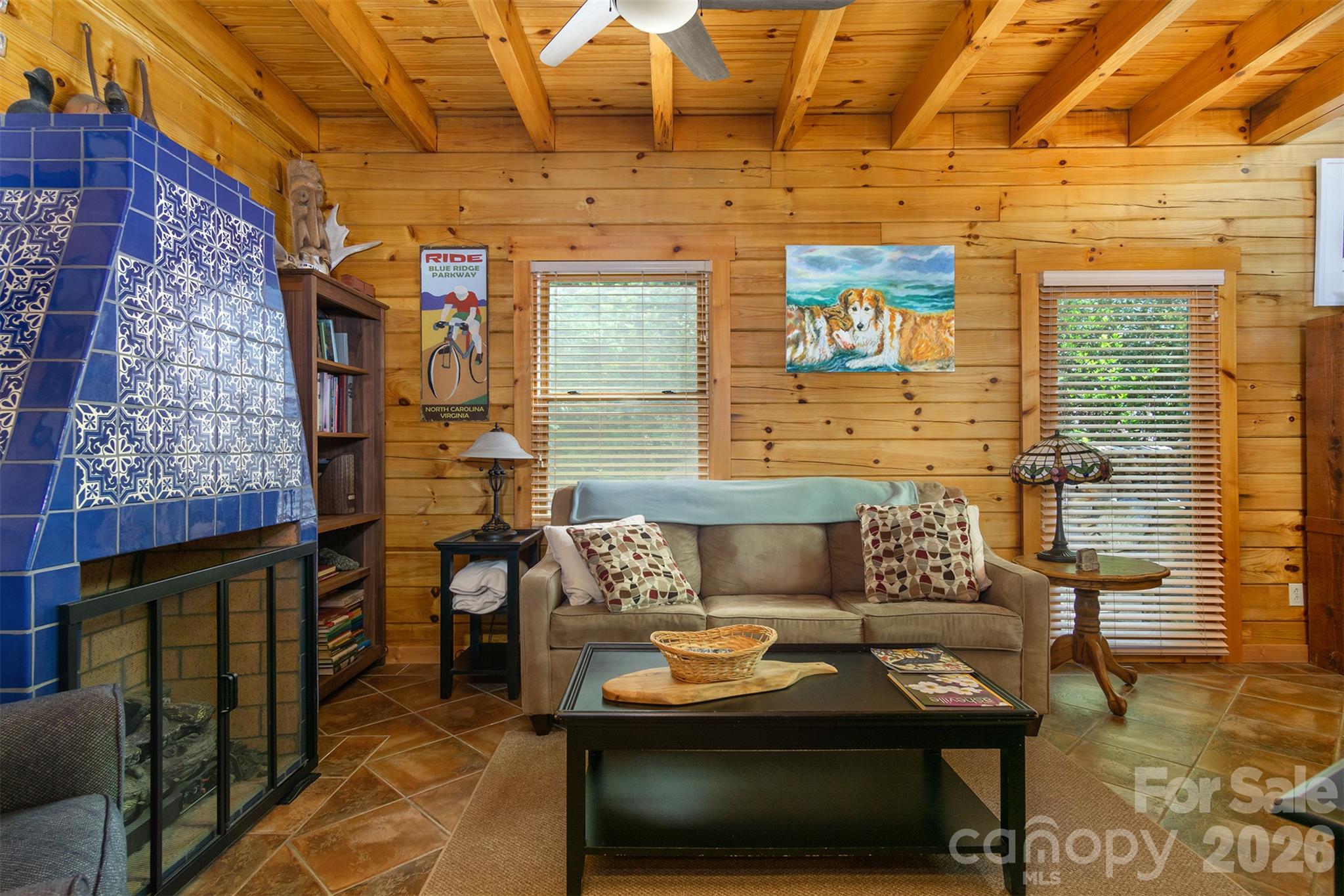 Living area has a gas log fire place Mexican tiles and custom tile work. - 171 Camp Elliott Road, Black Mountain