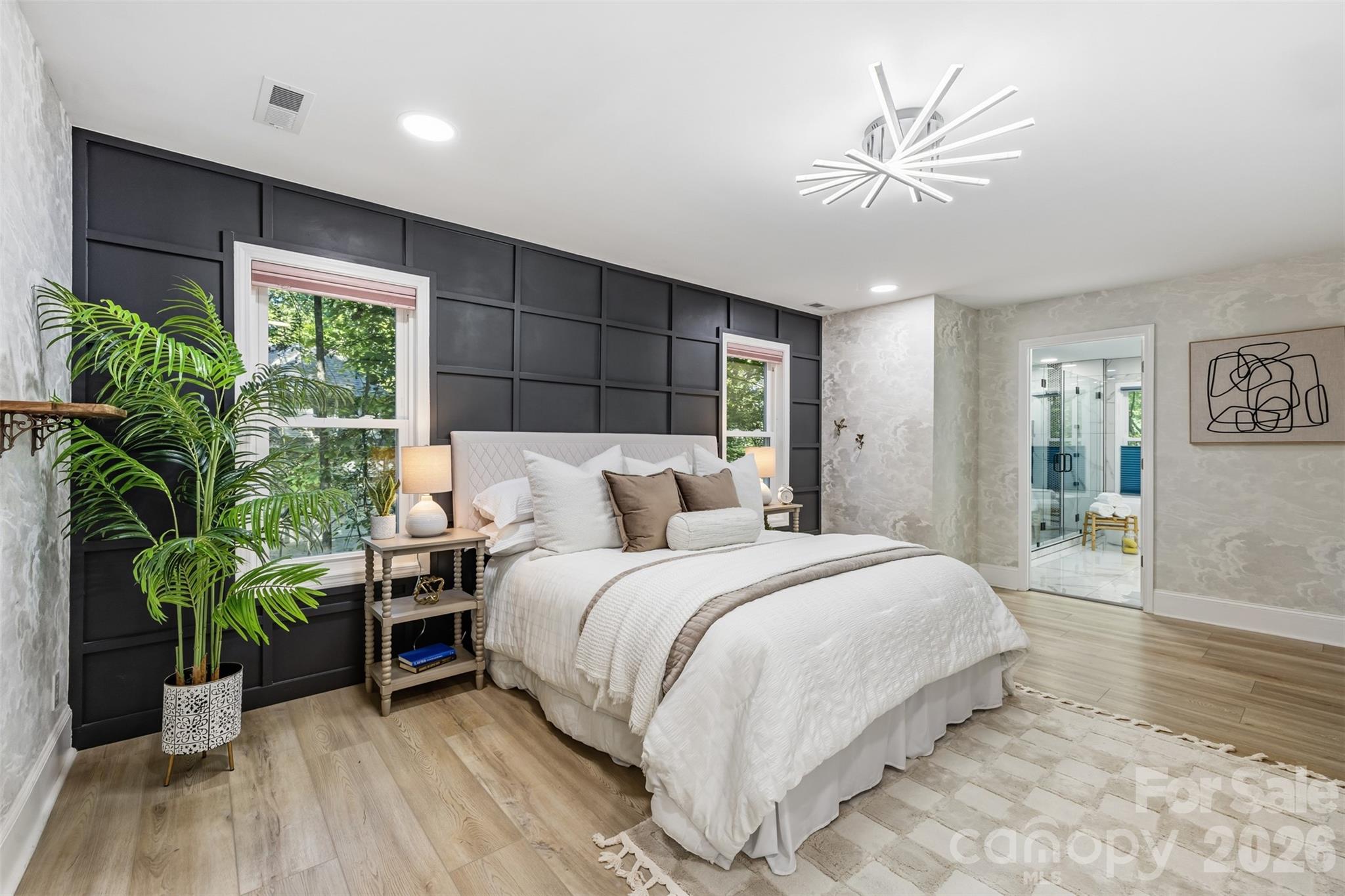 Large primary suite features LVP & wood paneled accent wall - 16 Tanglewood Road, Lake Wylie