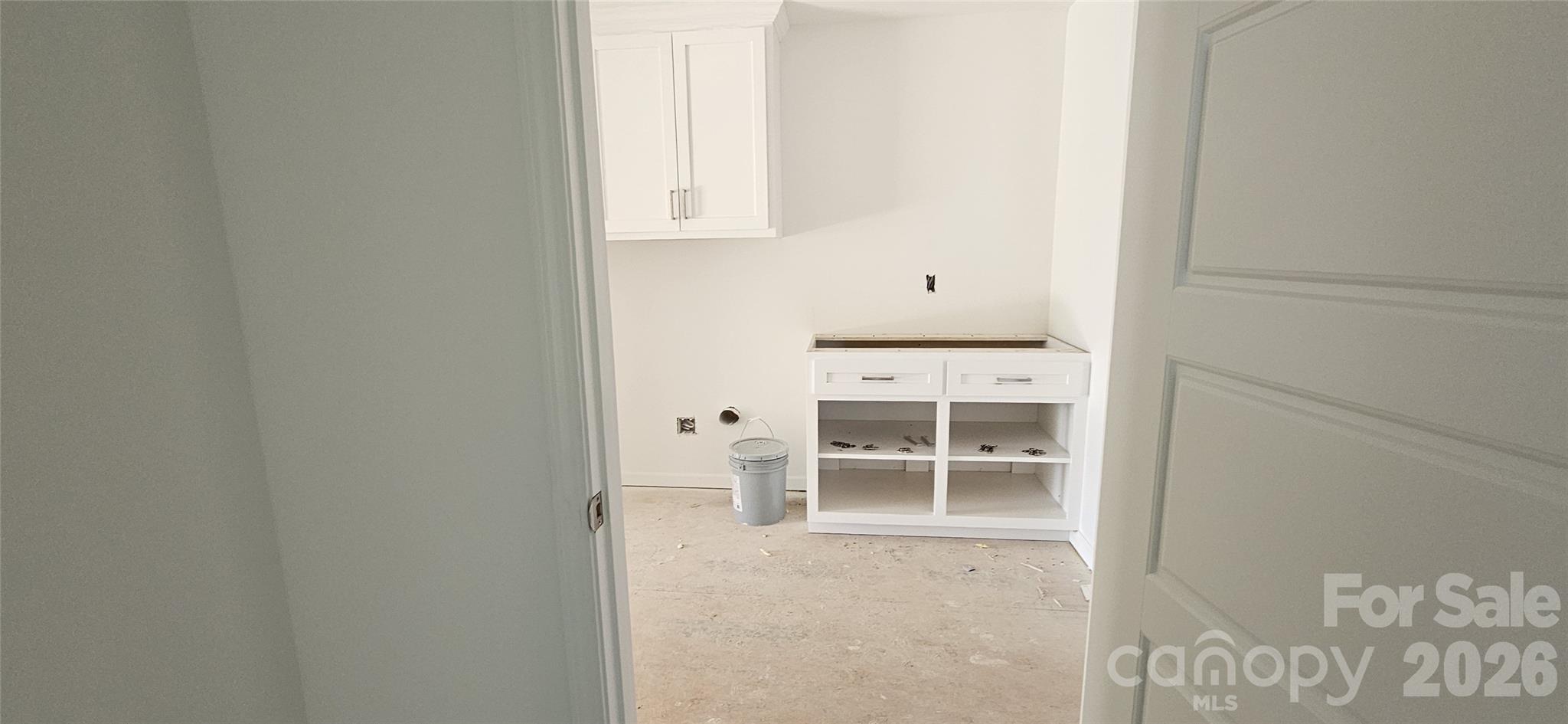 laundry room from primary walk-in closet - 3684 Woodgreen Drive, Lincolnton