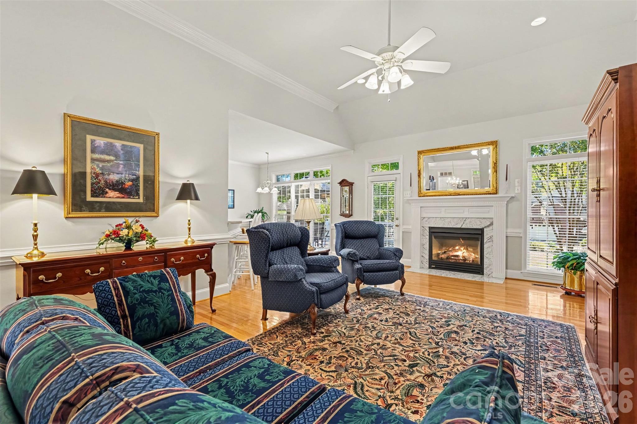 Great Room features beautiful hardwood flooring, Gas Fireplace, transomes over windows for lots of natural lighting. Open Floorplan. - 8412 Locksley Drive, Harrisburg