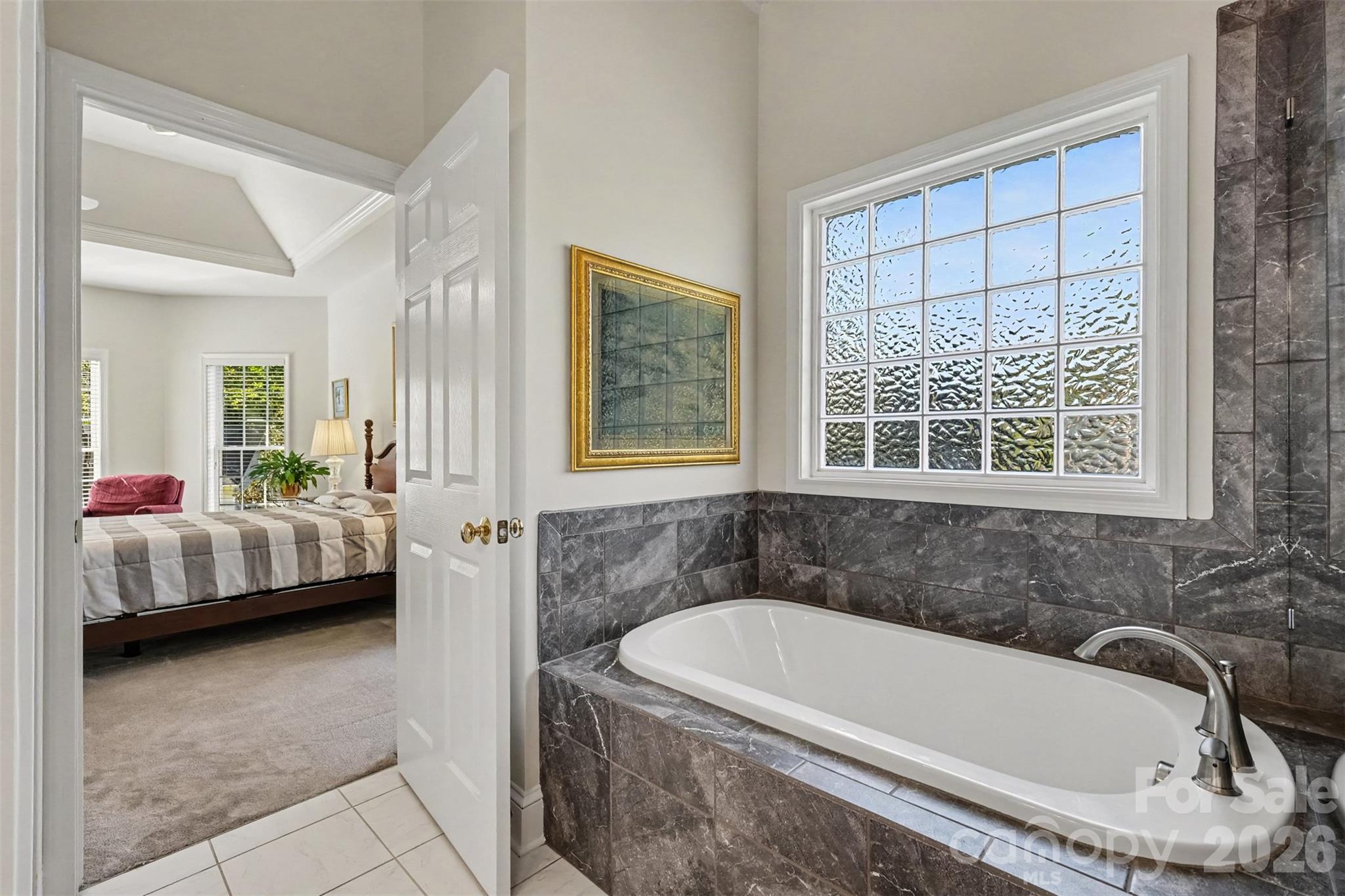 Primary Bathtub has been updated with beautiful gray tile. Linen Closet behind the door. - 8412 Locksley Drive, Harrisburg