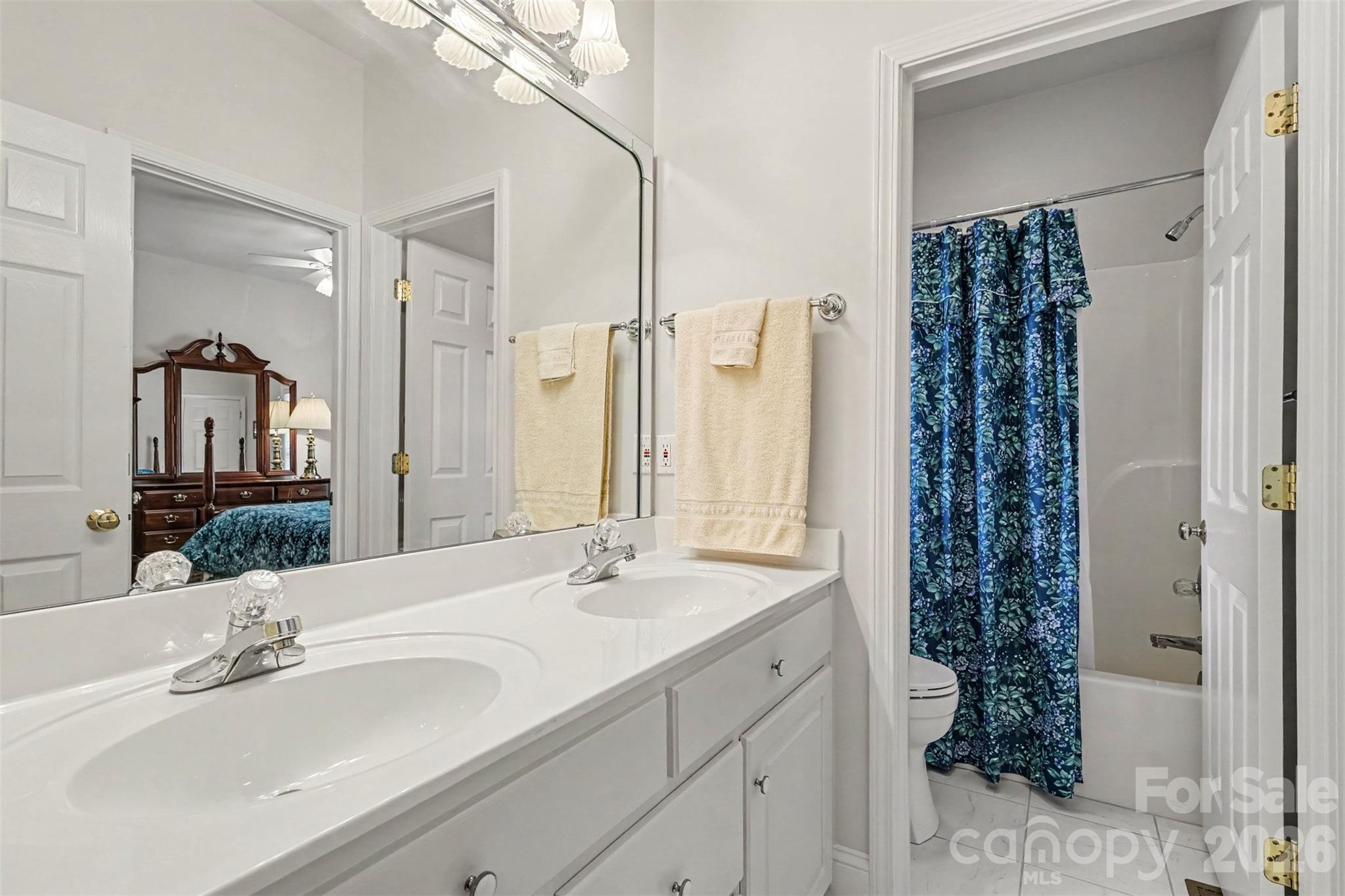 Jack and Jill Bathrom between Bedrooms 2 and 3 on Main Floor. Dual Vanities, neutral paint throughout. Window in Shower/Toilet Room. - 8412 Locksley Drive, Harrisburg