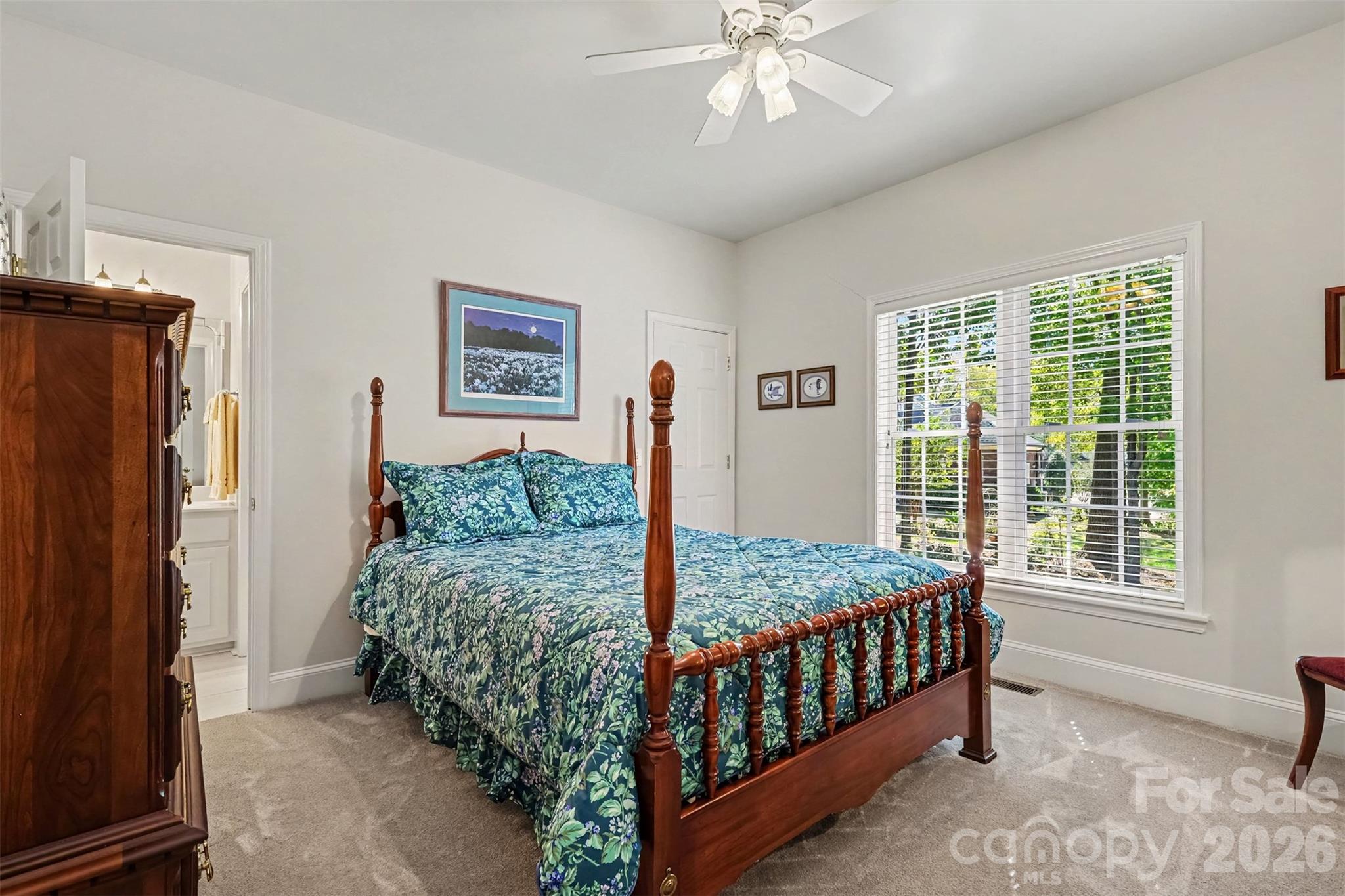 Bedroom 3 on the main level with walk in closet and Jack and Jill Bathroom. Neutral paint and carpet. - 8412 Locksley Drive, Harrisburg