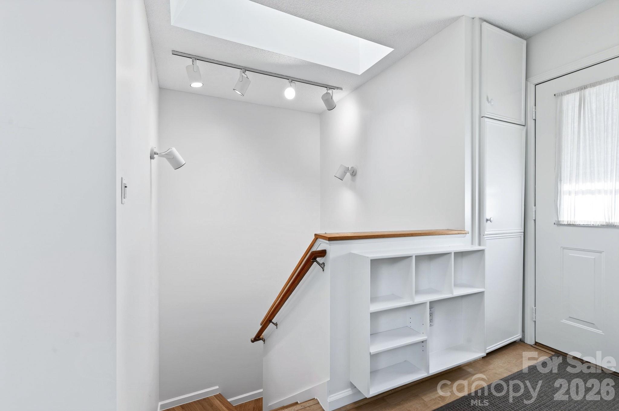 Lower level stairs off front entry includes additional built ins - 43 Vermont Court, Asheville