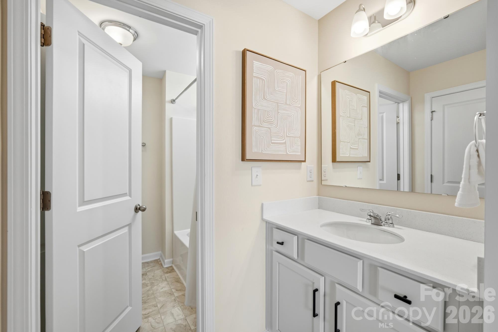 Entry to jack and jill bathroom with private sink - 7656 Tanglewood Way, Denver