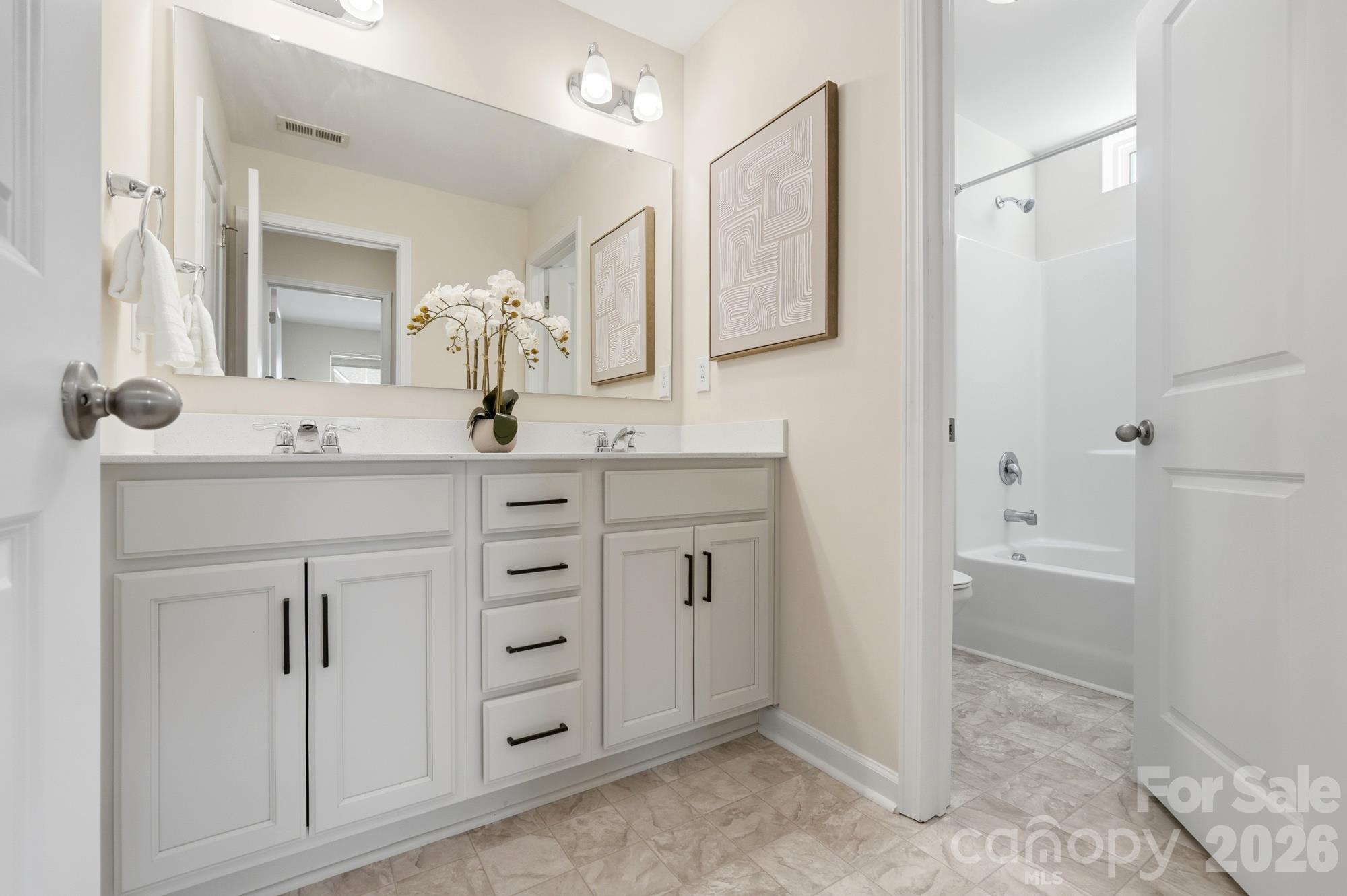 Jack and Jill bathroom with dual vanity - 7656 Tanglewood Way, Denver
