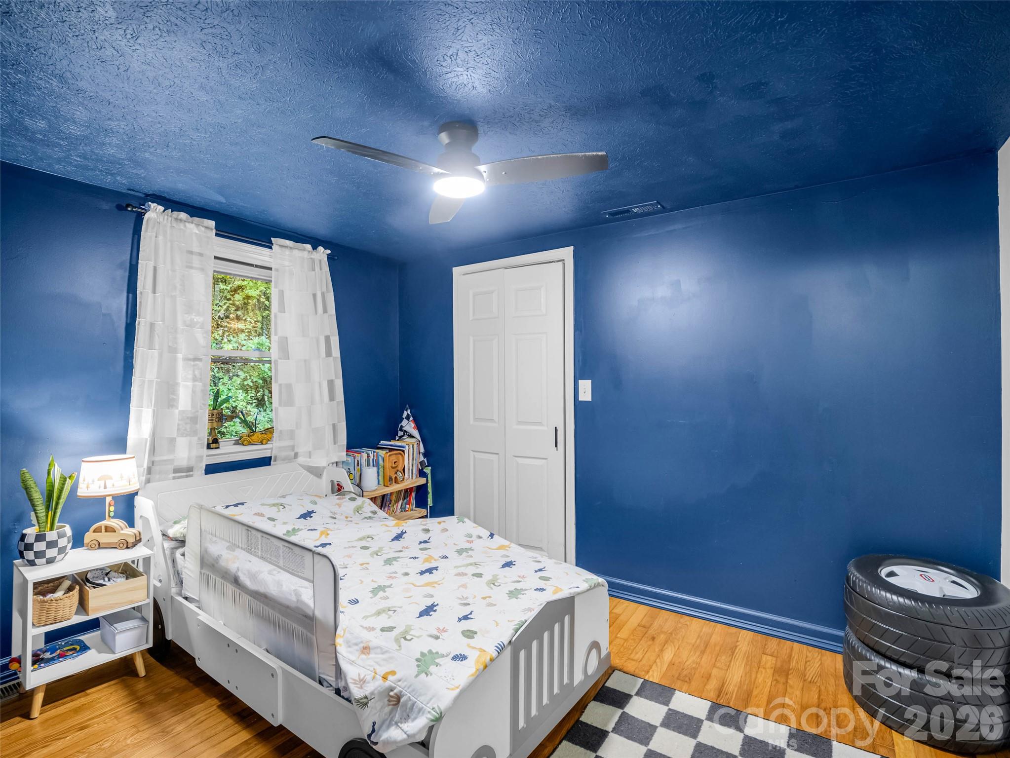 A cheerful bedroom with hardwood floors and plenty of character. - 913 Dorothy Street, Hendersonville