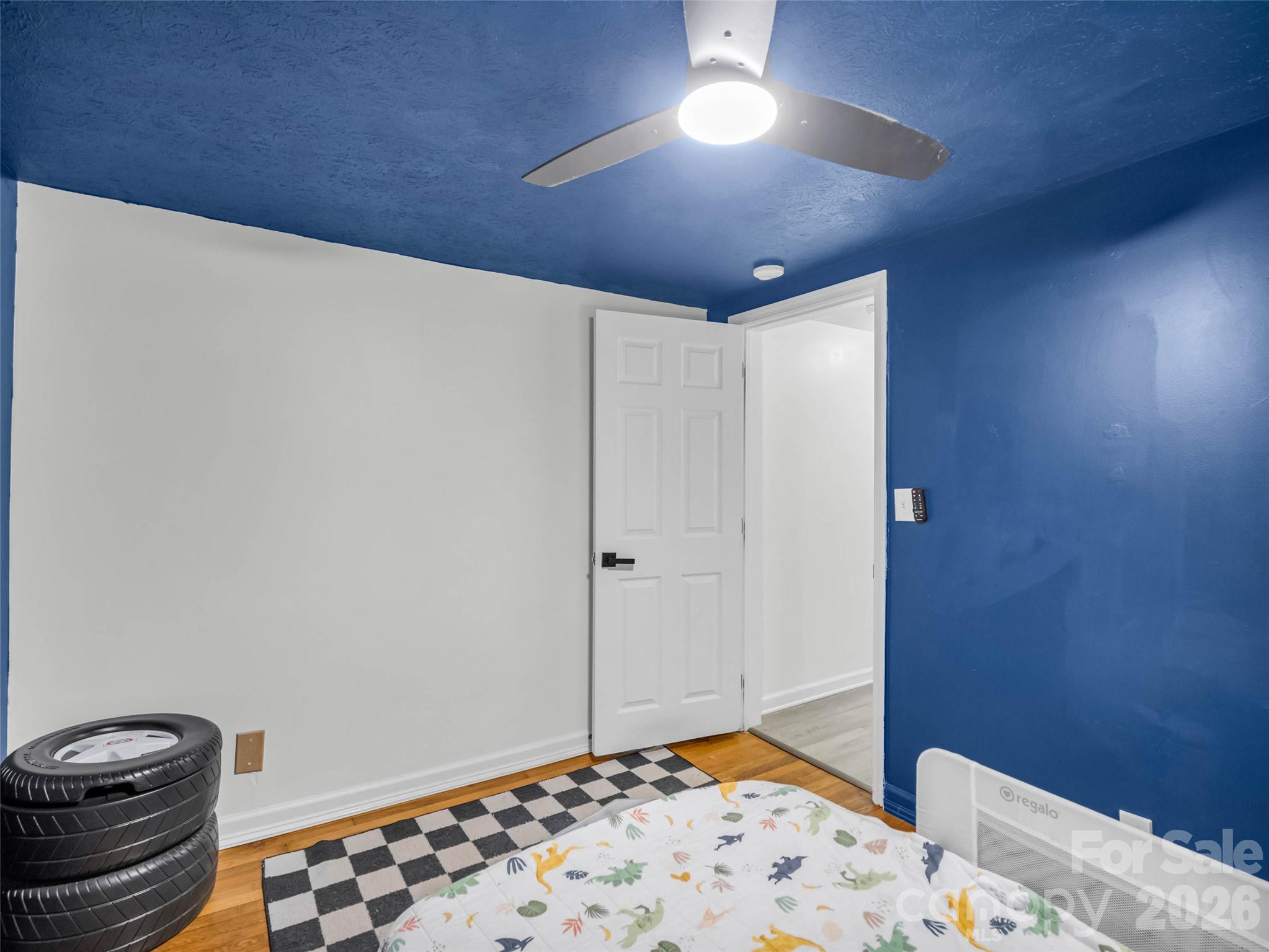 Another look at the bedroom and its distinctive blue walls. - 913 Dorothy Street, Hendersonville