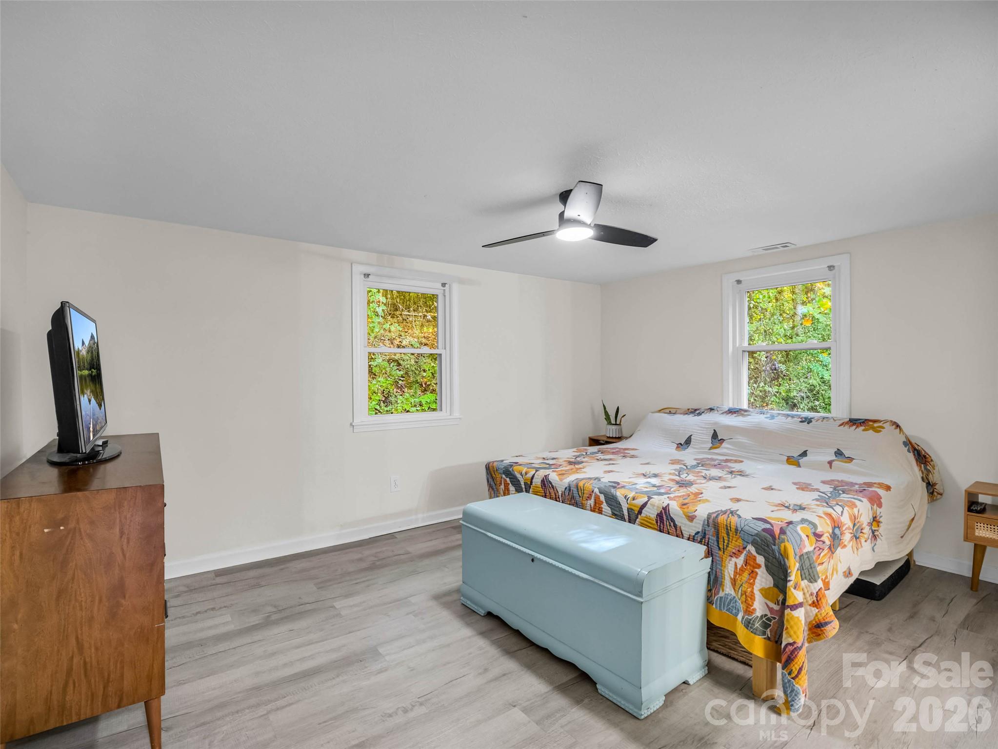 A comfortable primary bedroom with soft natural light. - 913 Dorothy Street, Hendersonville