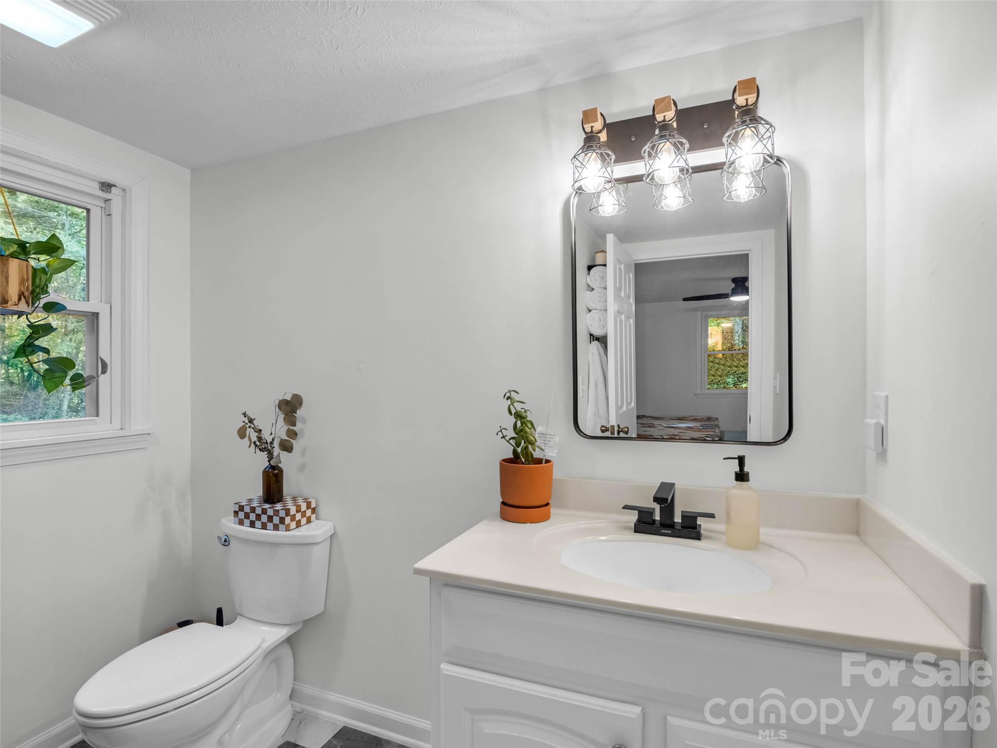 A bright main-level bathroom with a fresh, clean feel. - 913 Dorothy Street, Hendersonville