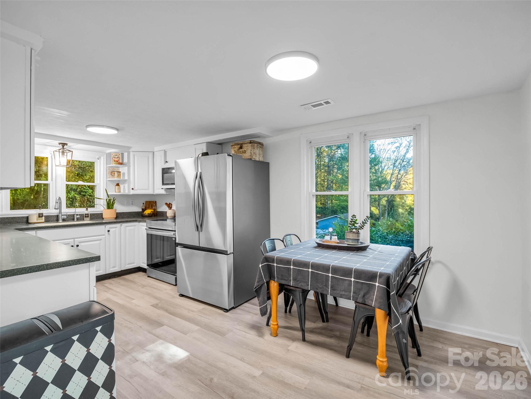 A sunny dining area makes everyday meals feel inviting. - 913 Dorothy Street, Hendersonville