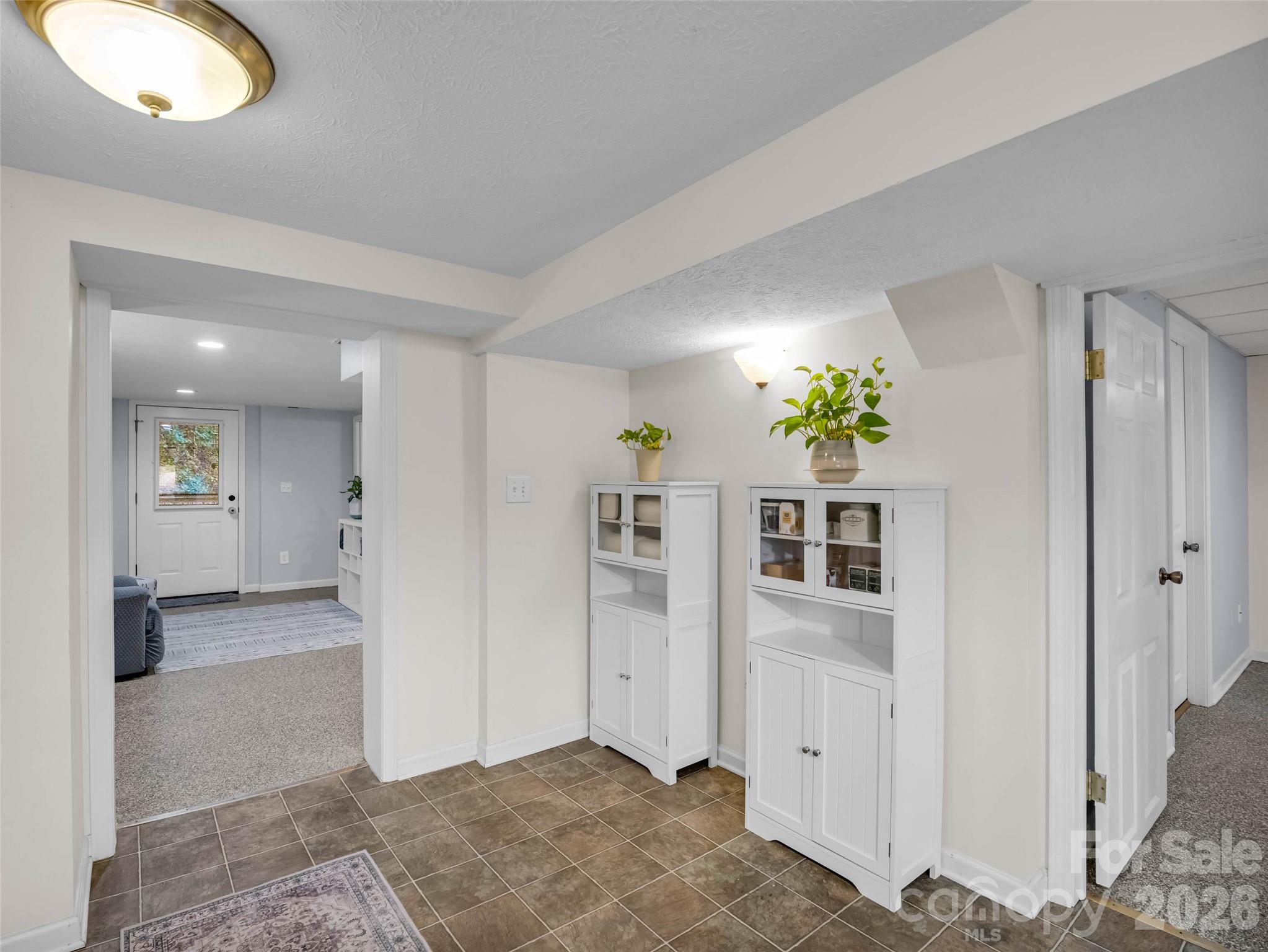 The lower level connects its own kitchen and living spaces. - 913 Dorothy Street, Hendersonville