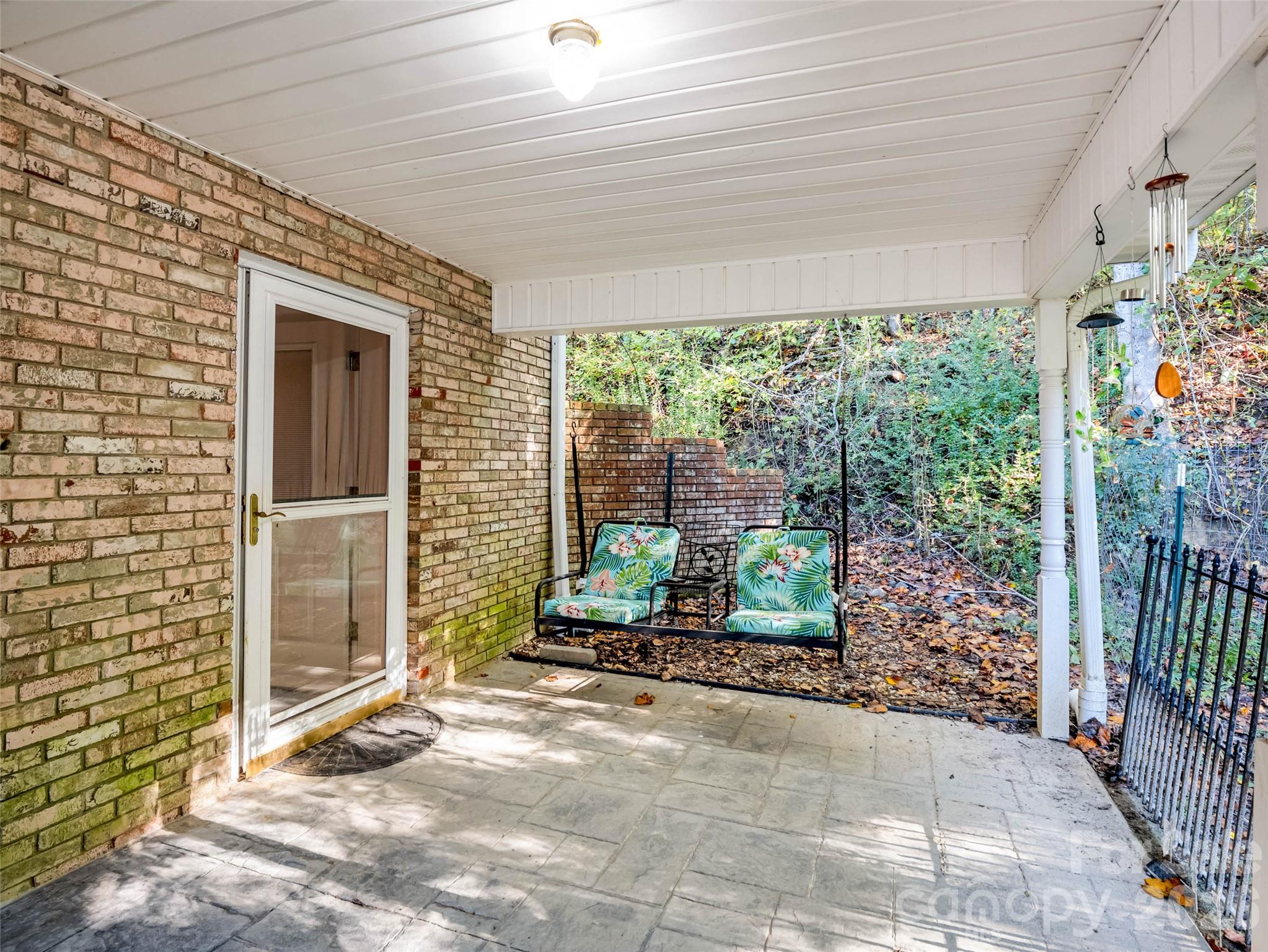 A covered lower-level entrance provides its own place to come and go. - 913 Dorothy Street, Hendersonville