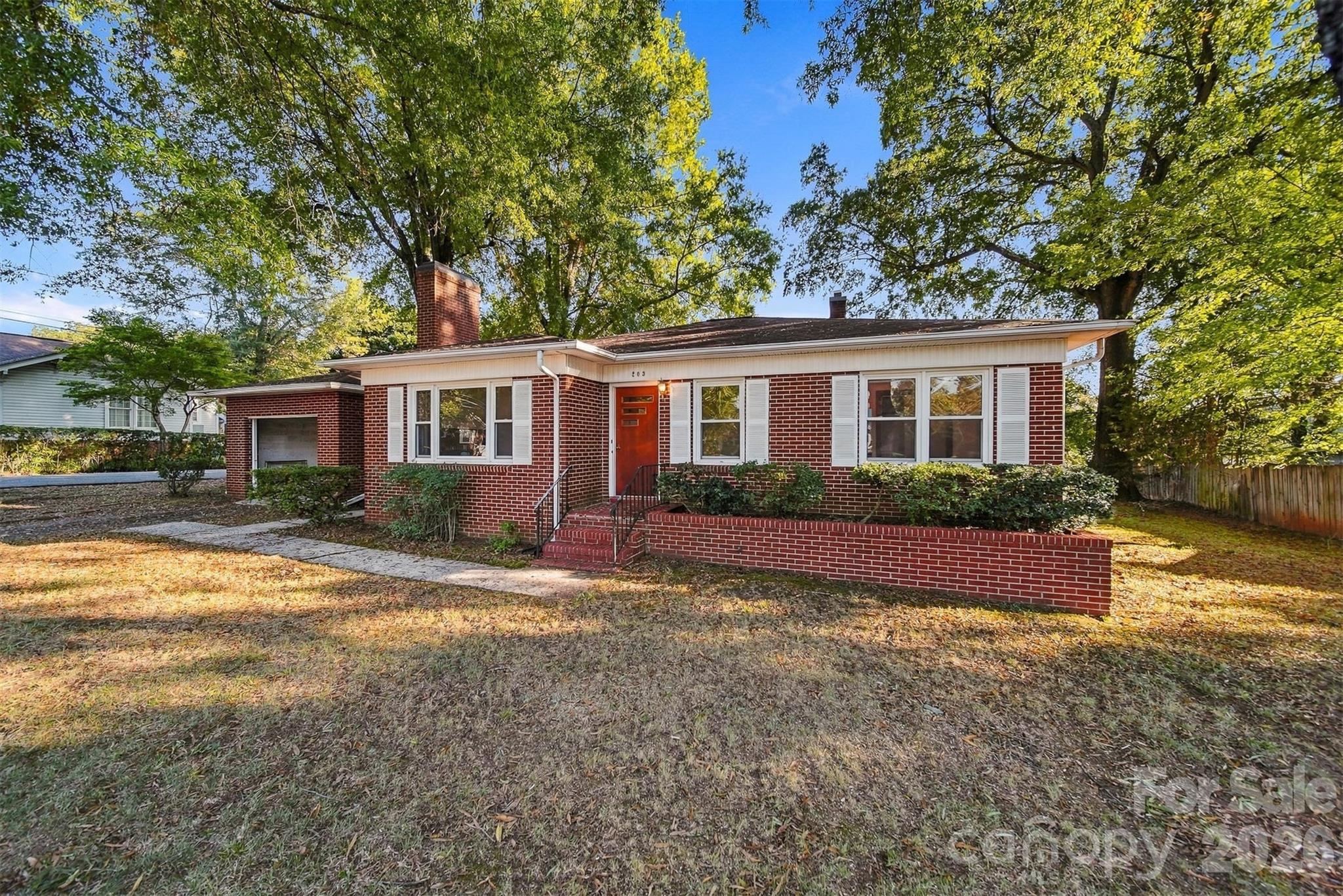 Home features a one car garage attached with a breezeway. - 203 W 21st Street, Newton