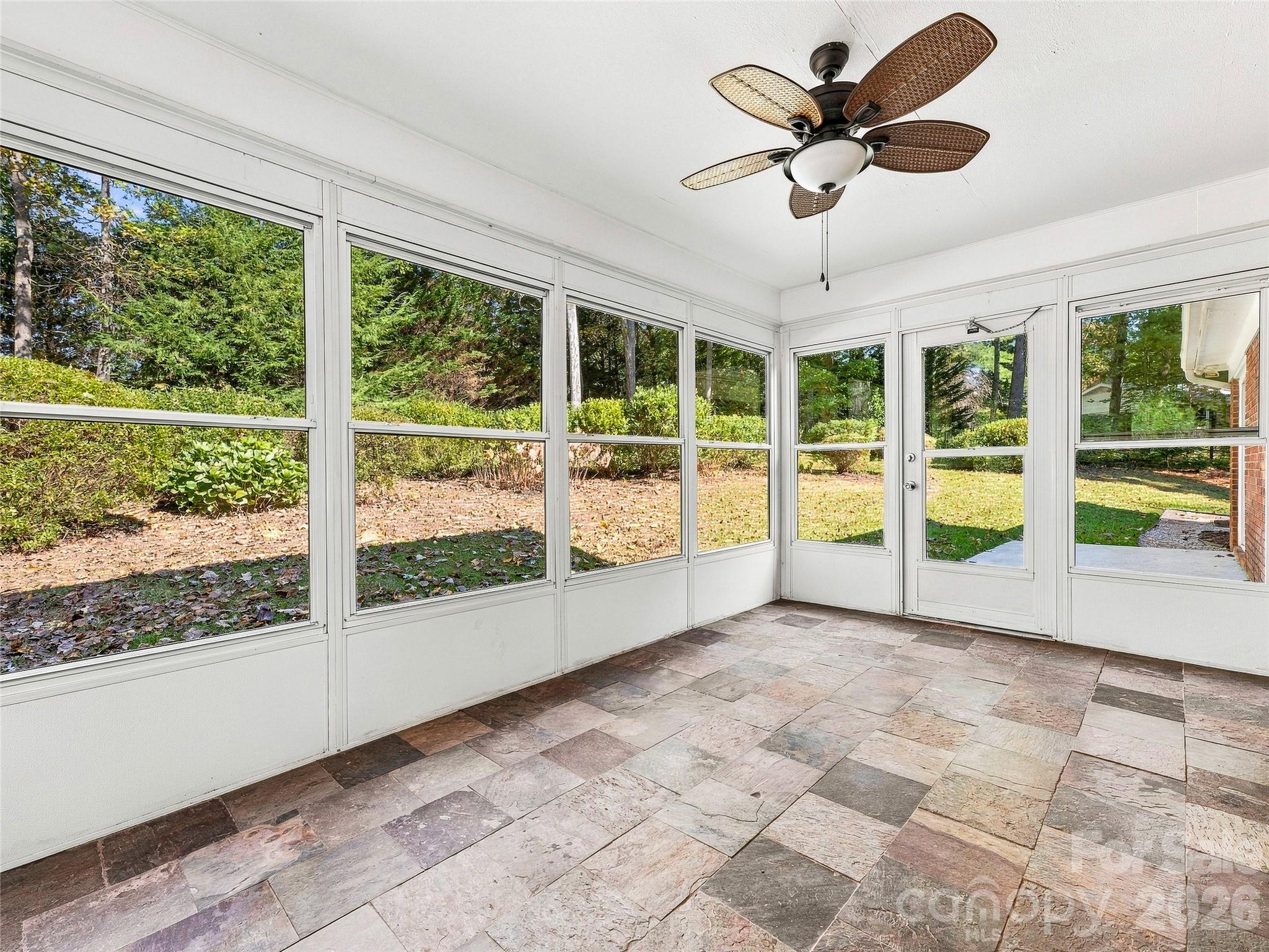 Tiled Sunroom w/ View of the Lush Backyard - 133 Kent Lane, Hendersonville